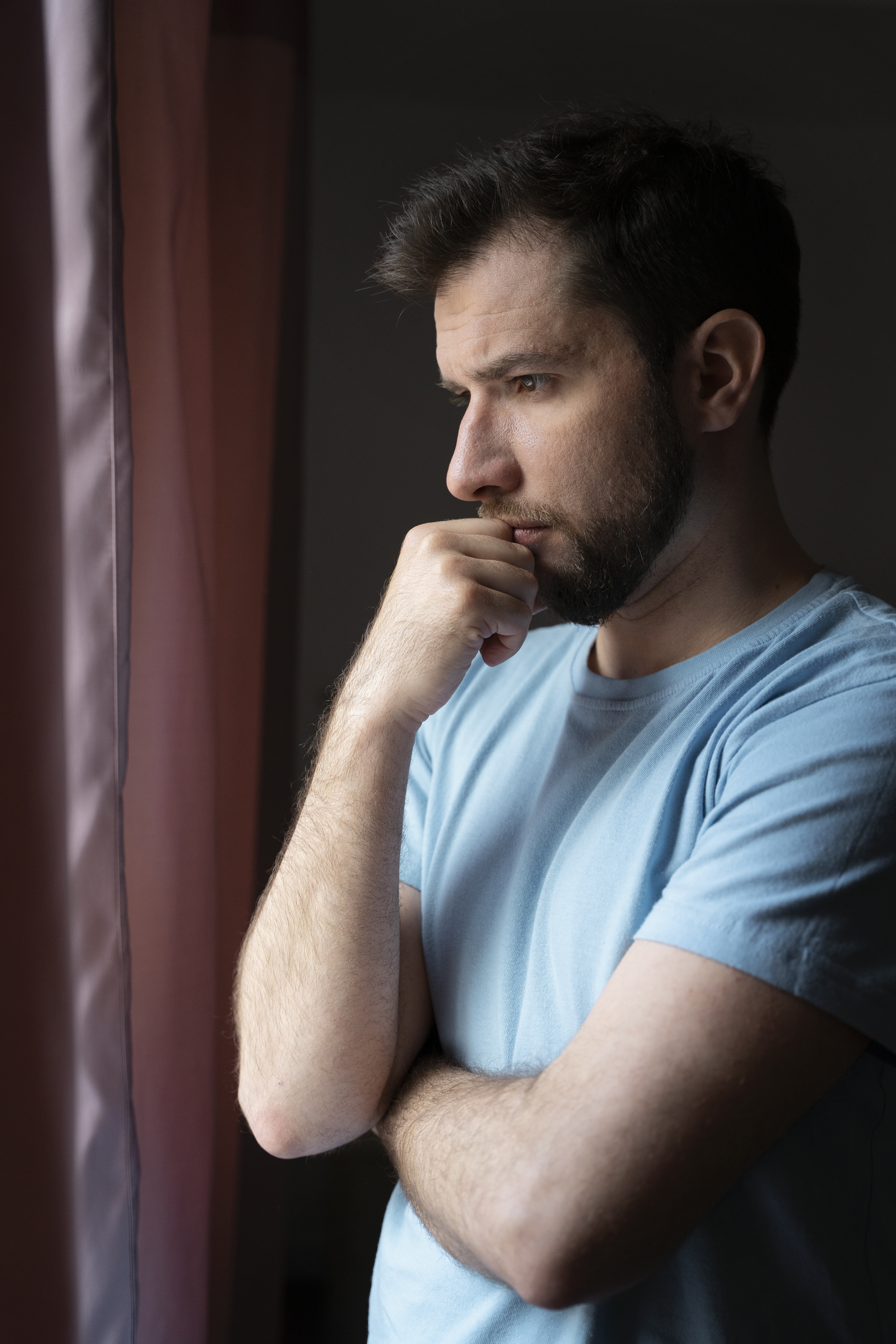 Man thinking while facing a window | Source: Freepik.com