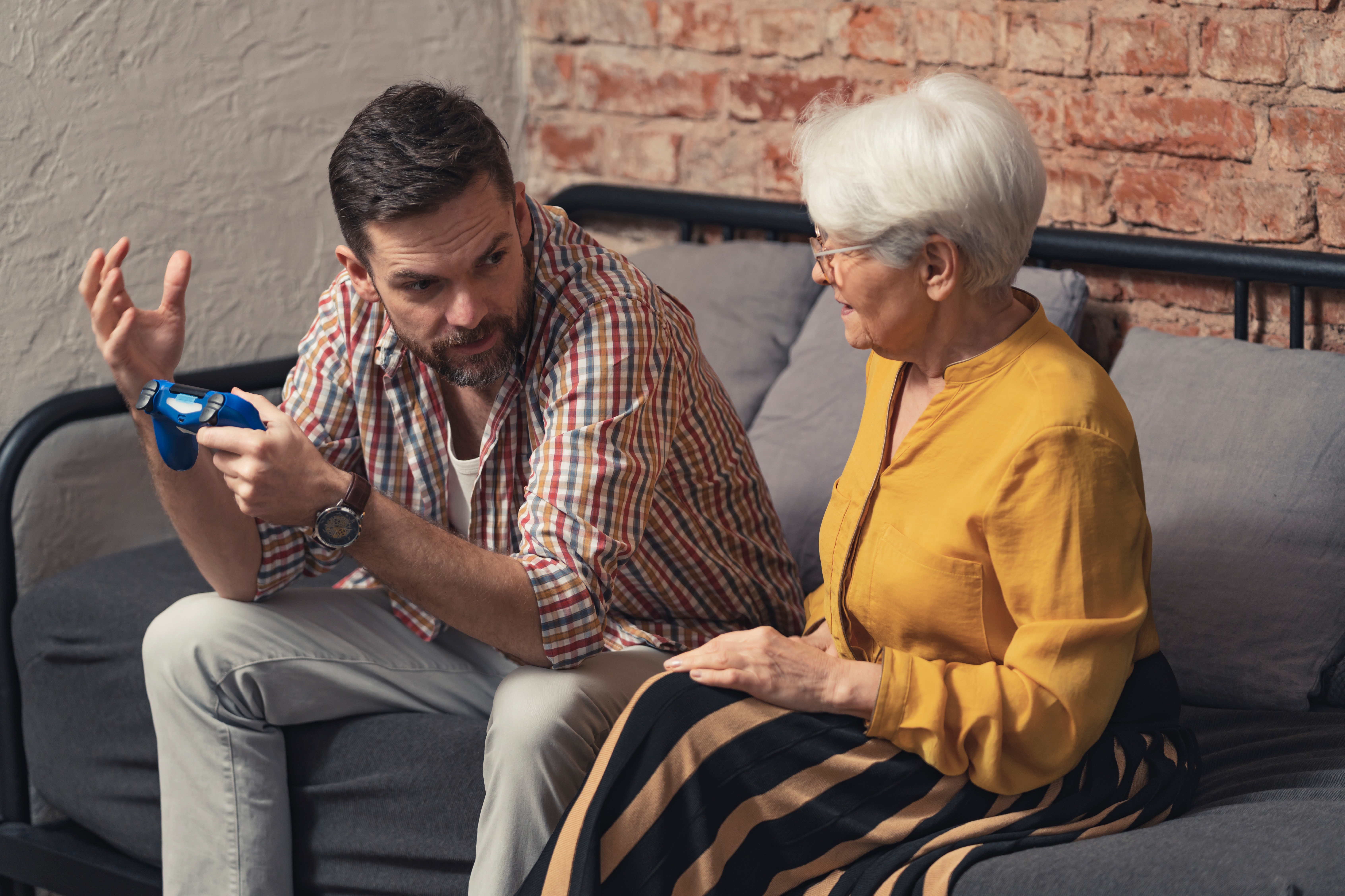 A man talking with an elderly woman | Source: Shutterstock