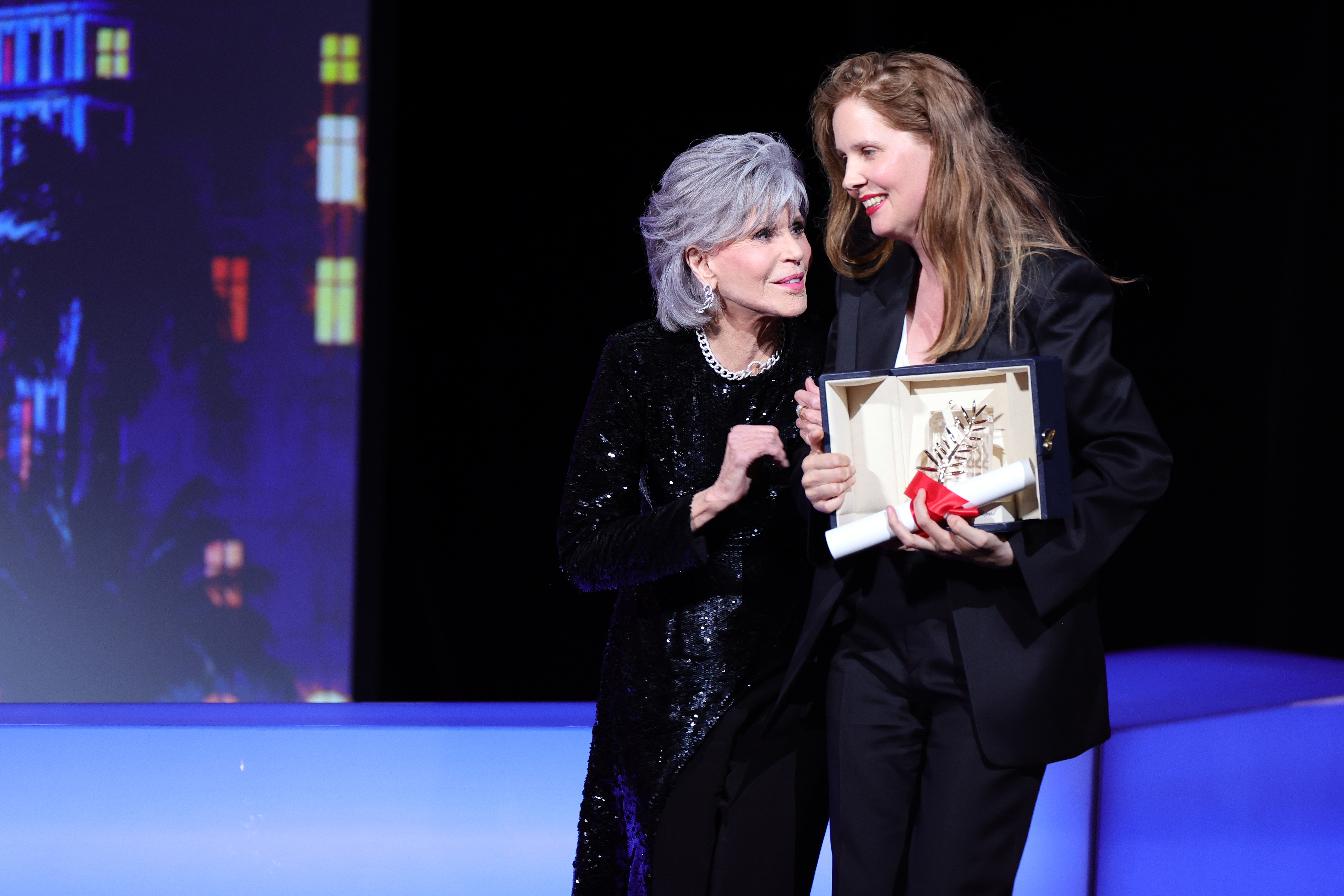 Justine Triet (R) receives The Palme D'Or Award for 'Anatomy of a Fall' from Jane Fonda (L) during the closing ceremony of the 76th annual Cannes Film Festival at Palais des Festivals on May 27, 2023 in Cannes, France | Source: Getty Images