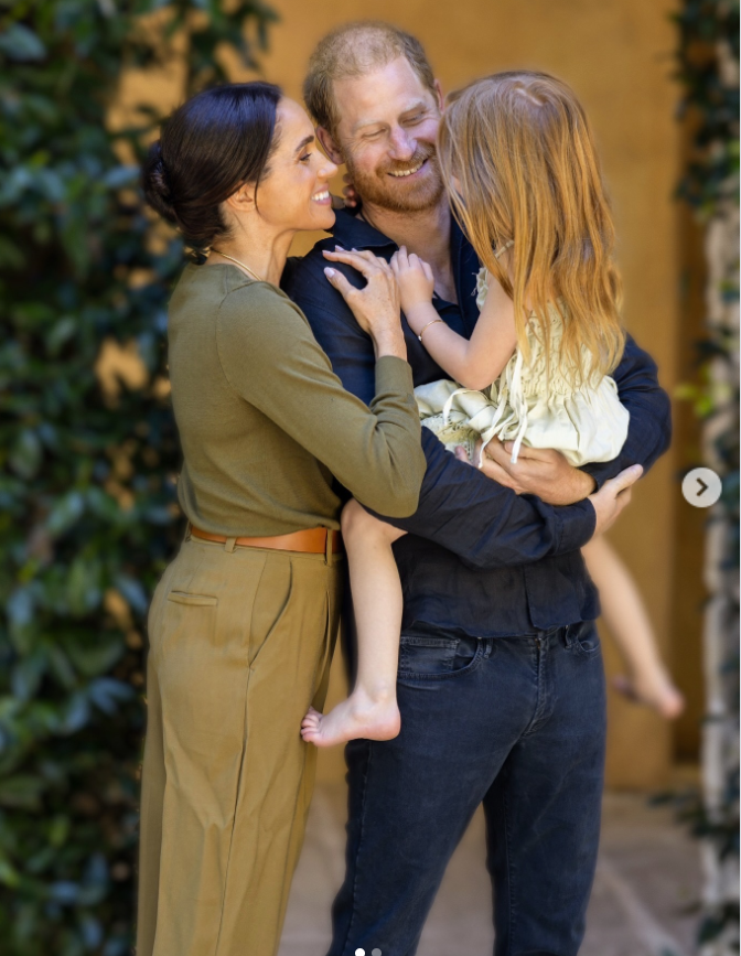 Meghan Markle and Prince Harry share a joyful family moment as they smile at Princess Lilibet, who is cradled in her father's arms. | Source: Instagram/meghan