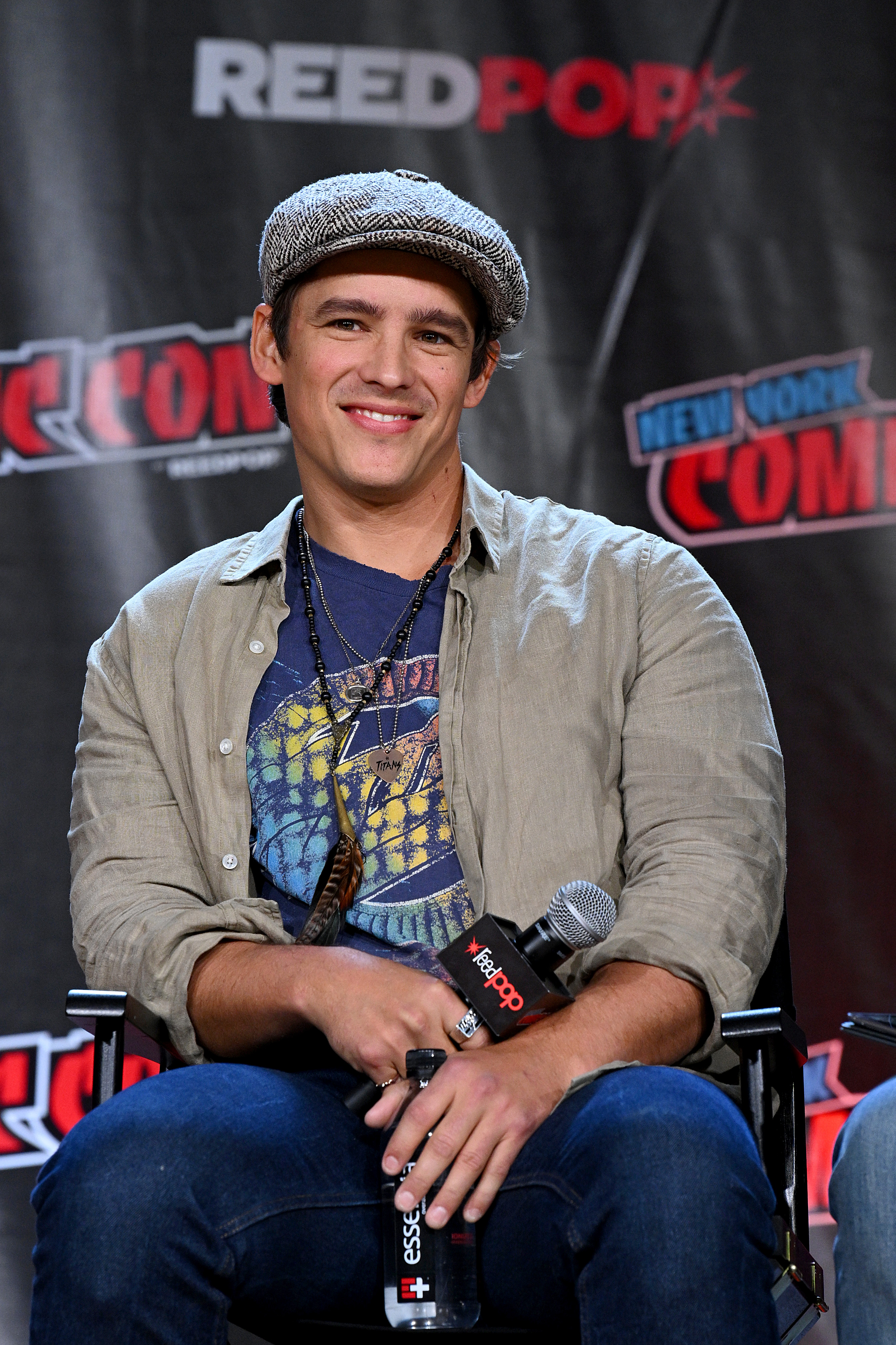 Brenton Thwaites is pictured as he speaks onstage at HBO Max and DC's Doom Patrol and Titans panel during New York Comic Con 2022 on October 9, 2022, in New York City | Source: Getty Images