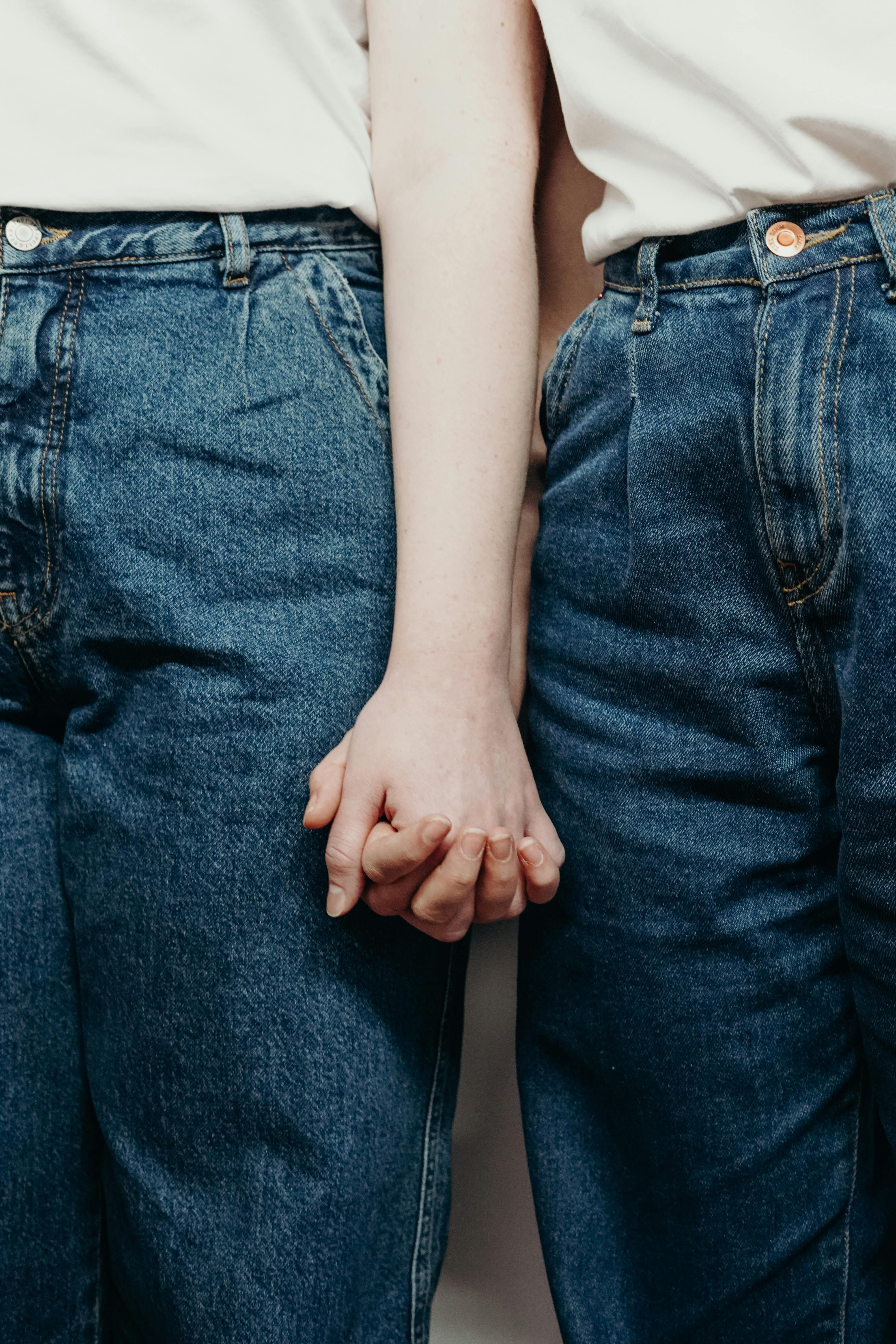 Two young women holding hands | Source: cottonbro studio on Pexels