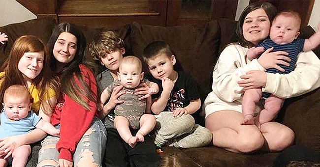 Britni Church's kids smiling while sitting next to each other. | Source: Instagram.com/our_large_family_life