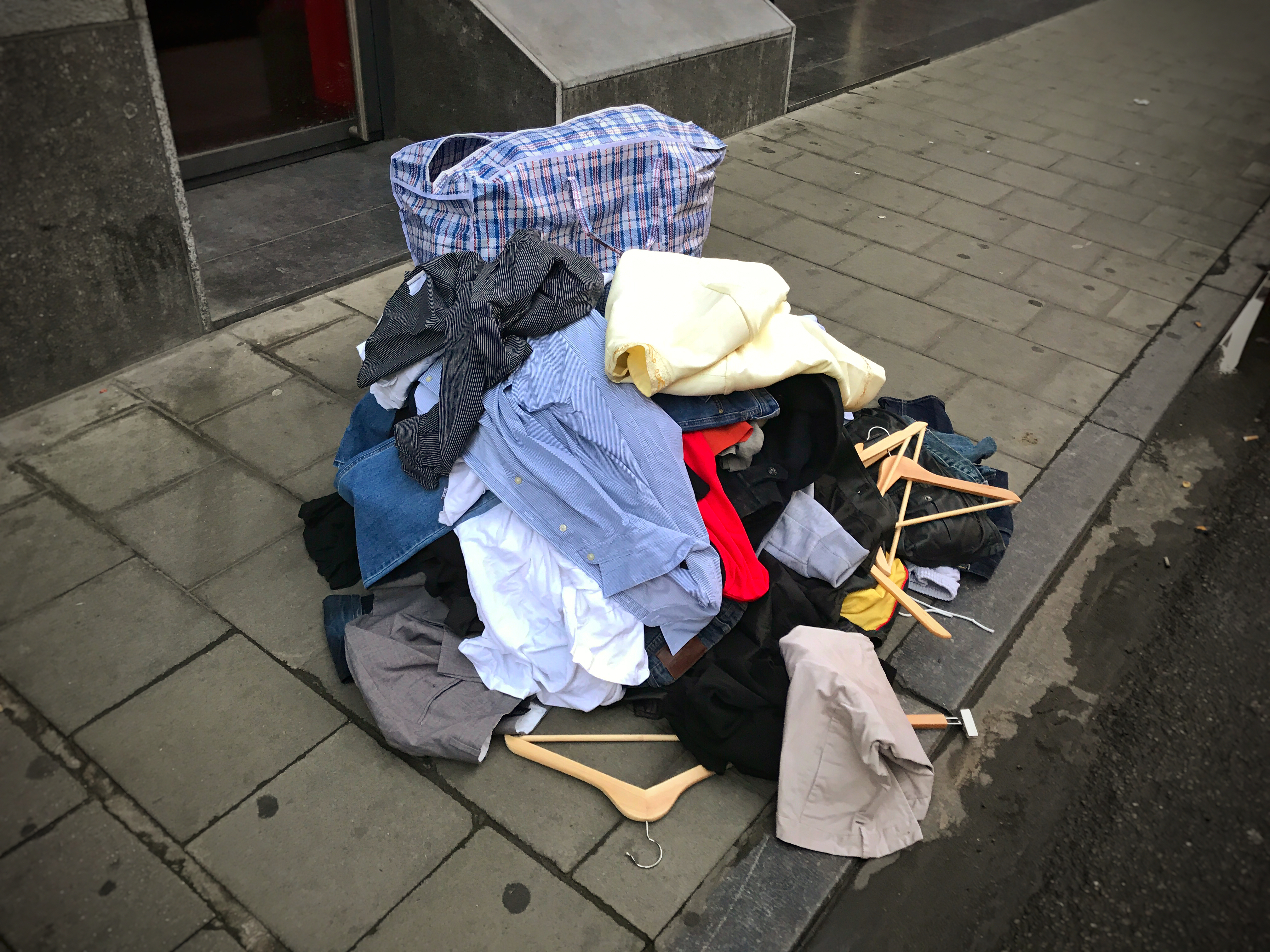 Pile of Clothes on Sidewalk. | Source: Shutterstock