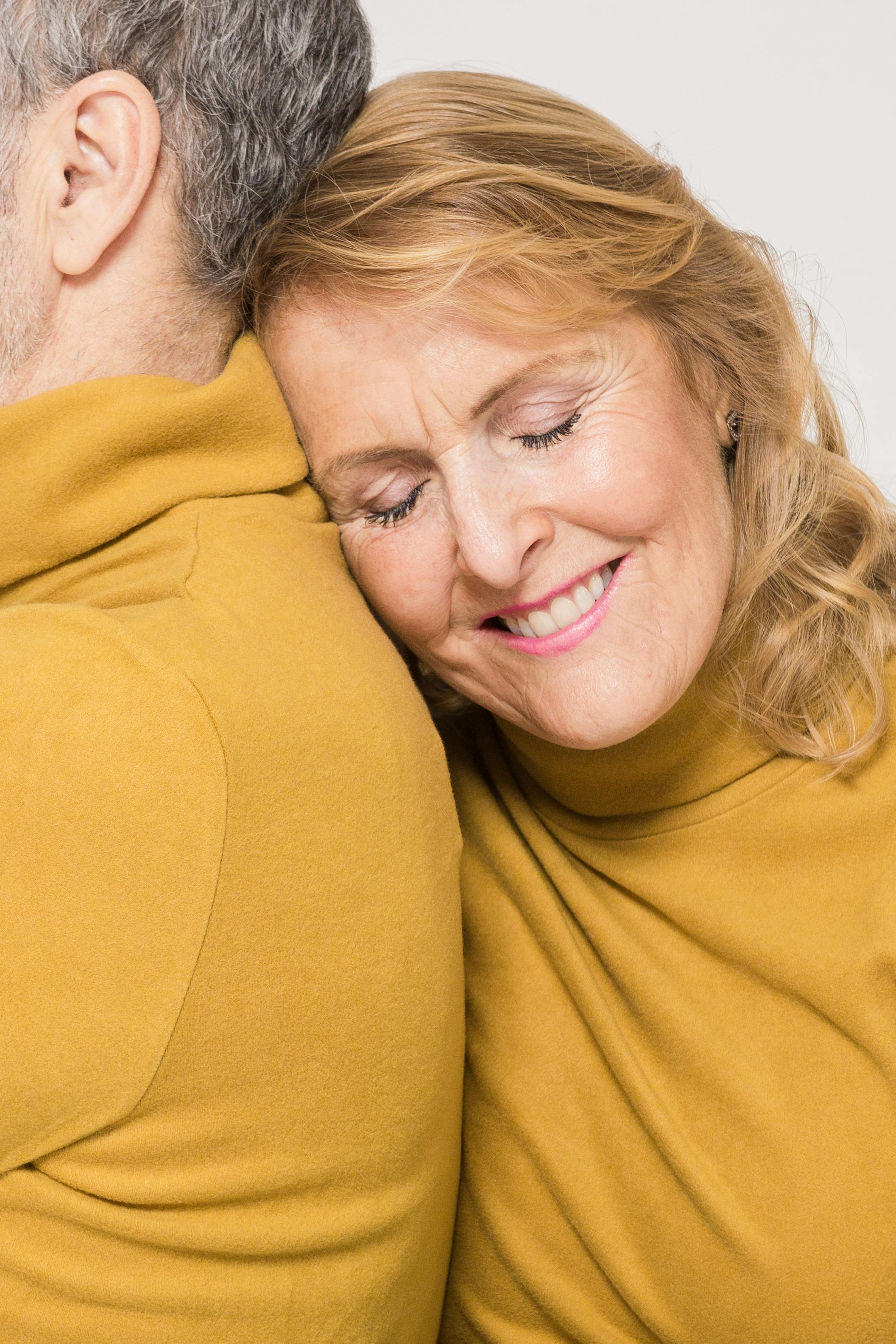 A woman smiling while leaning on her husband | Source: Pexels