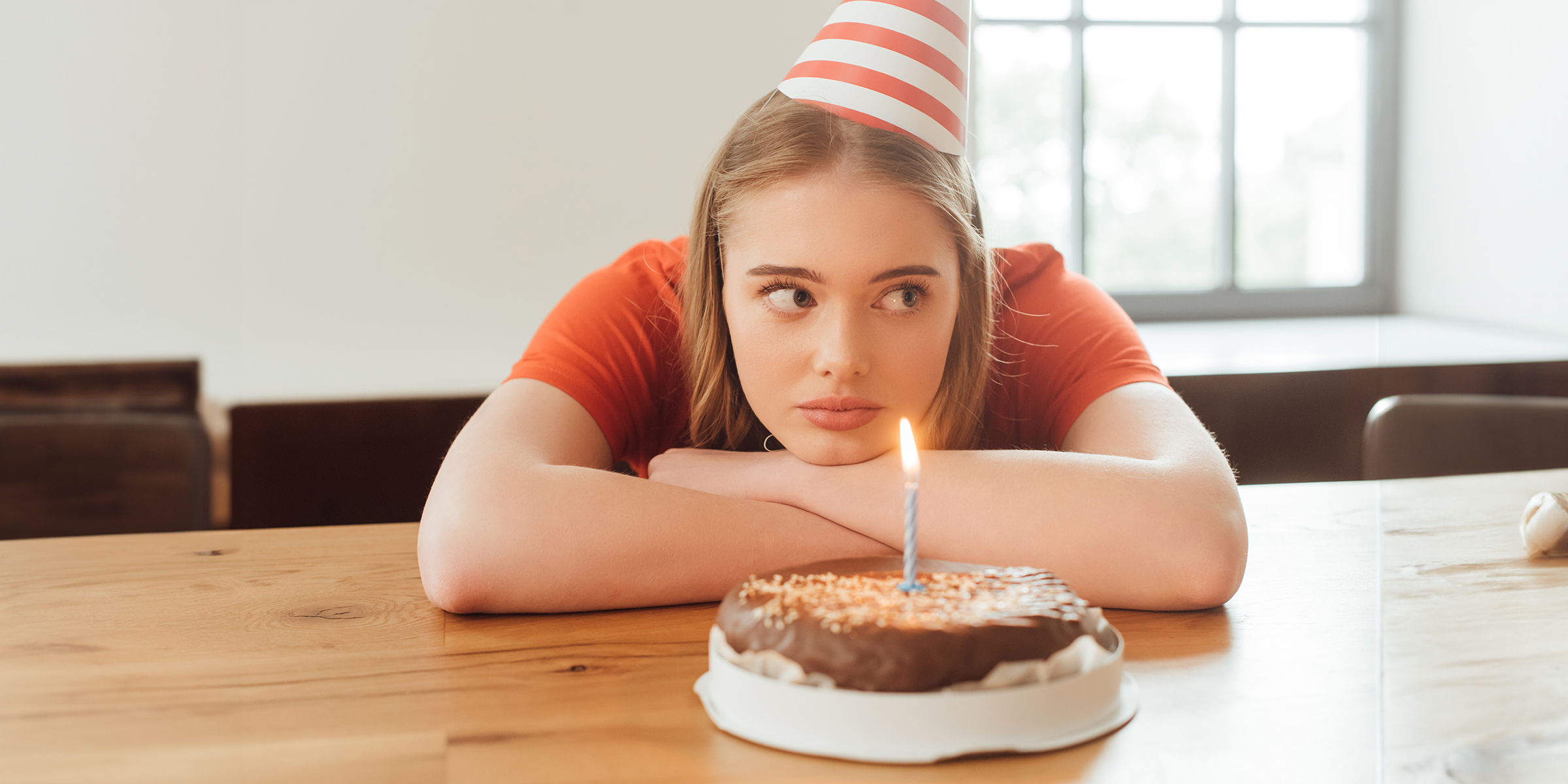 A bored girl with a cake | Source: Shutterstock