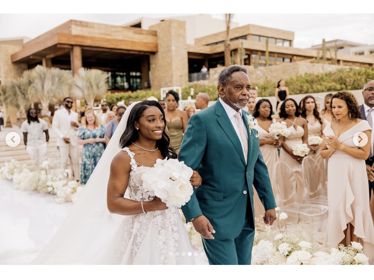 Simone Biles walks down the aisle with her father, as seen in a post dated May 9, 2023 | Source: Instagram/simonebiles