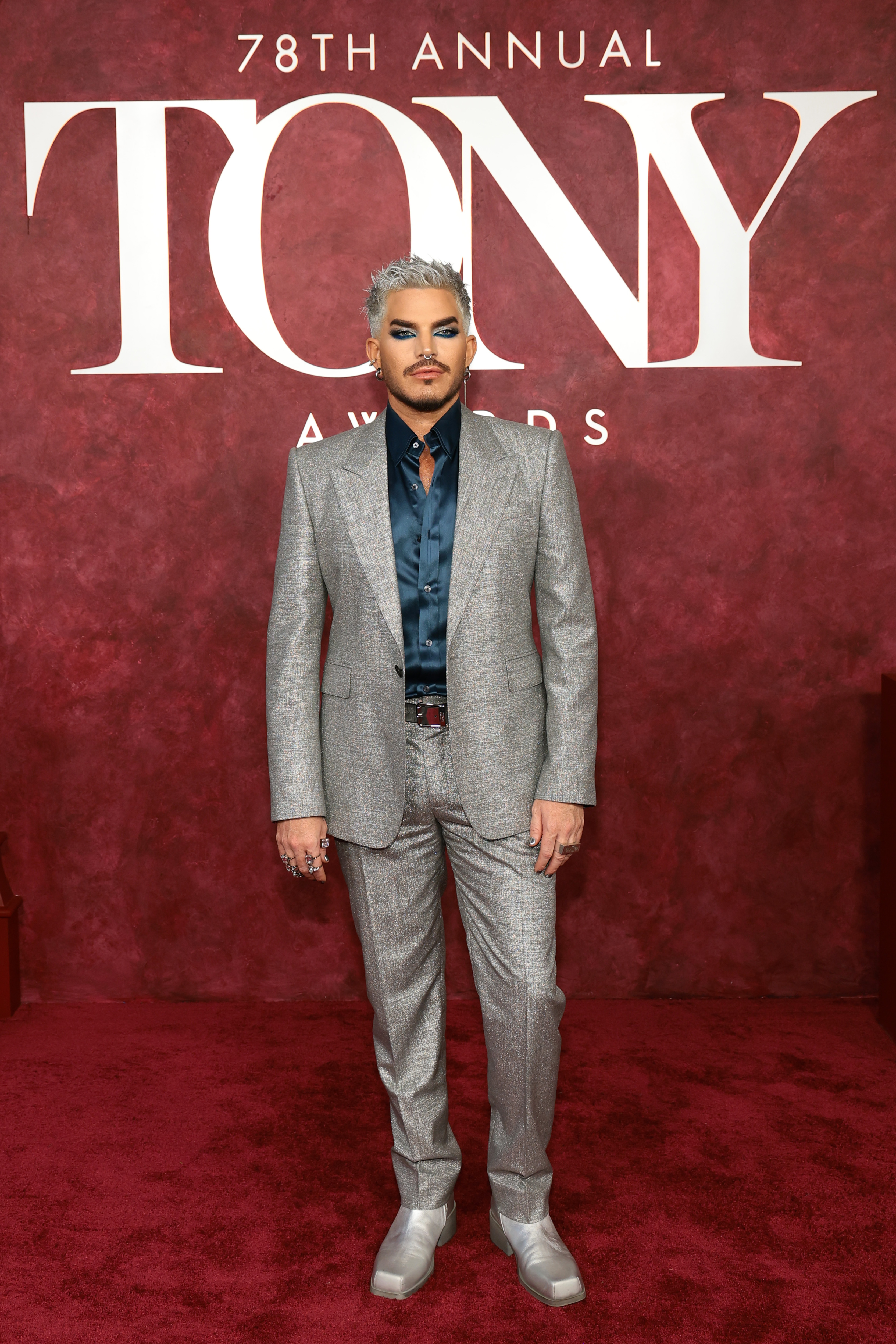 In a head-to-toe metallic ensemble, Adam Lambert stands with poise and purpose. The tailored fit, shimmering texture, and bold styling reflected his signature flair — commanding attention amid a night dedicated to theatrical excellence and creativity.
