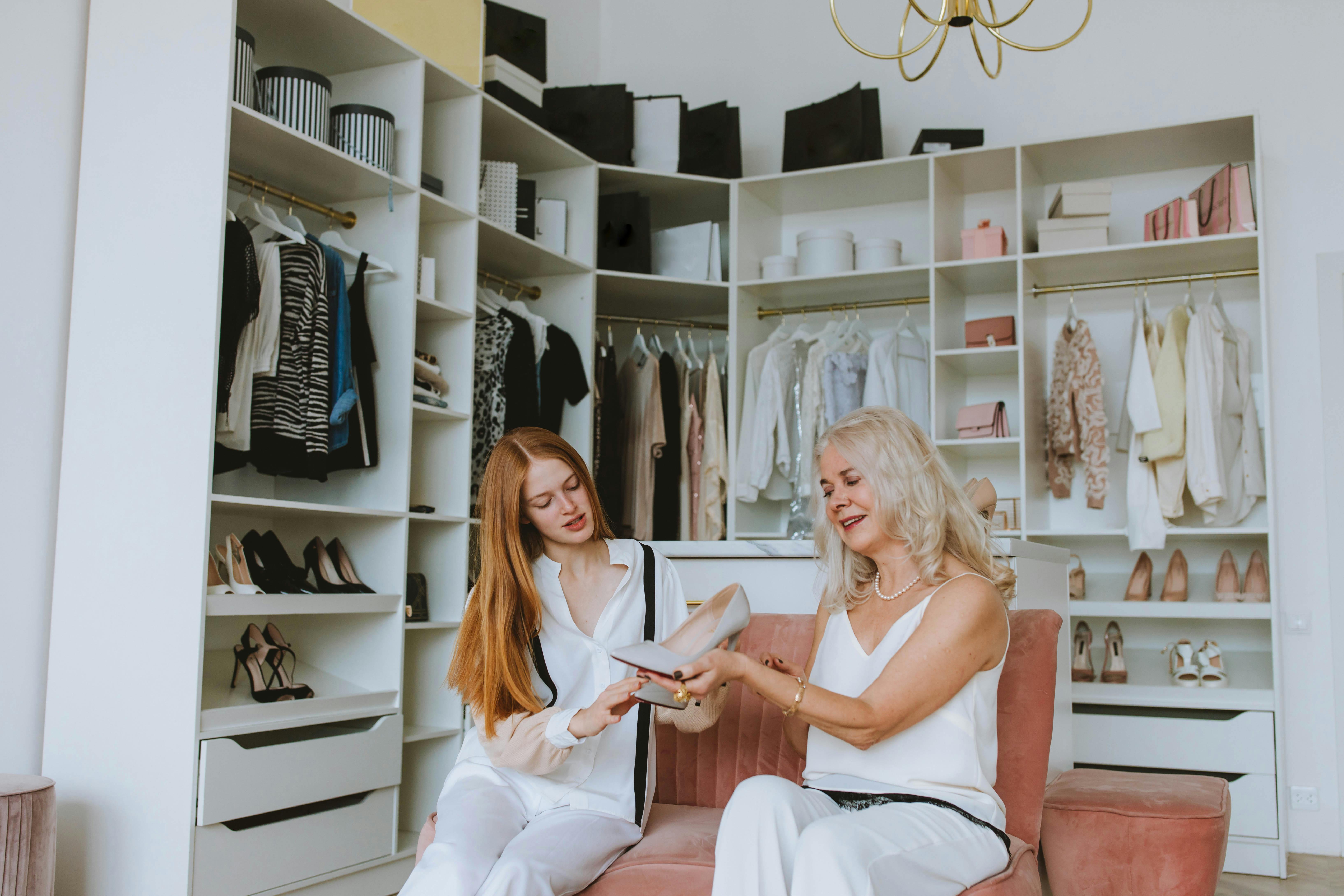 Two women looking at a pair of shoes | Source: Pexels