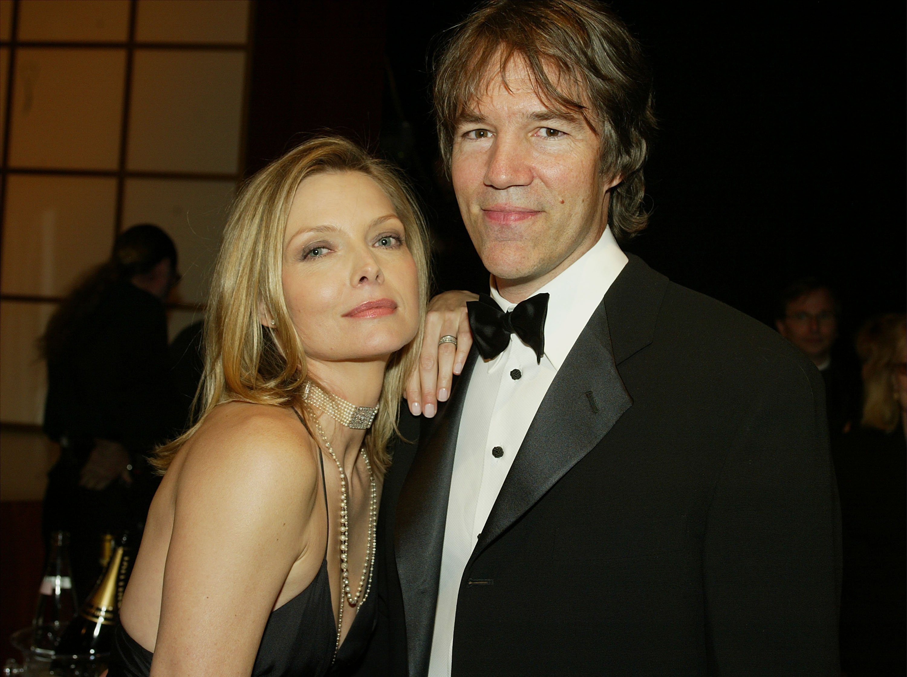 Actress Michelle Pfeiffer and David E. Kelley pose during the 9th Annual Screen Actors Guild Awards at the Shrine Auditorium on March 9, 2003 in Los Angeles, California. | Source: Getty Images