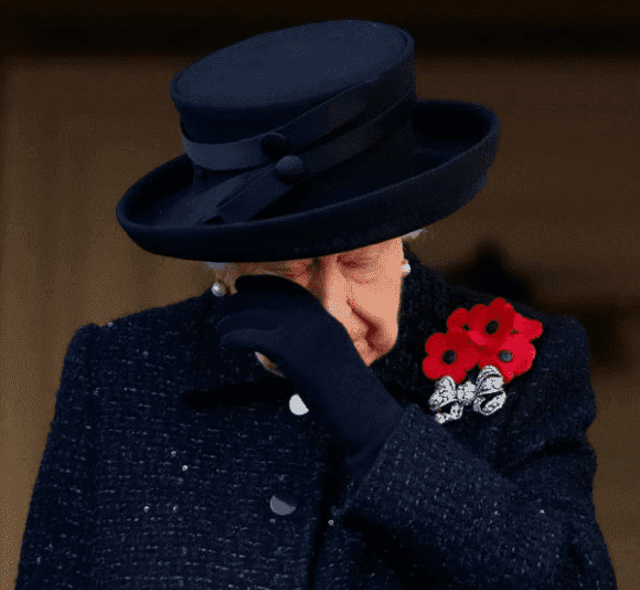 Queen Elizabeth wipes away tears while standing on a balcony watching the Remembrance Sunday service at The Cenotaph on November 10, 2019, in London, England | Source: Max Mumby/Indigo/Getty Images