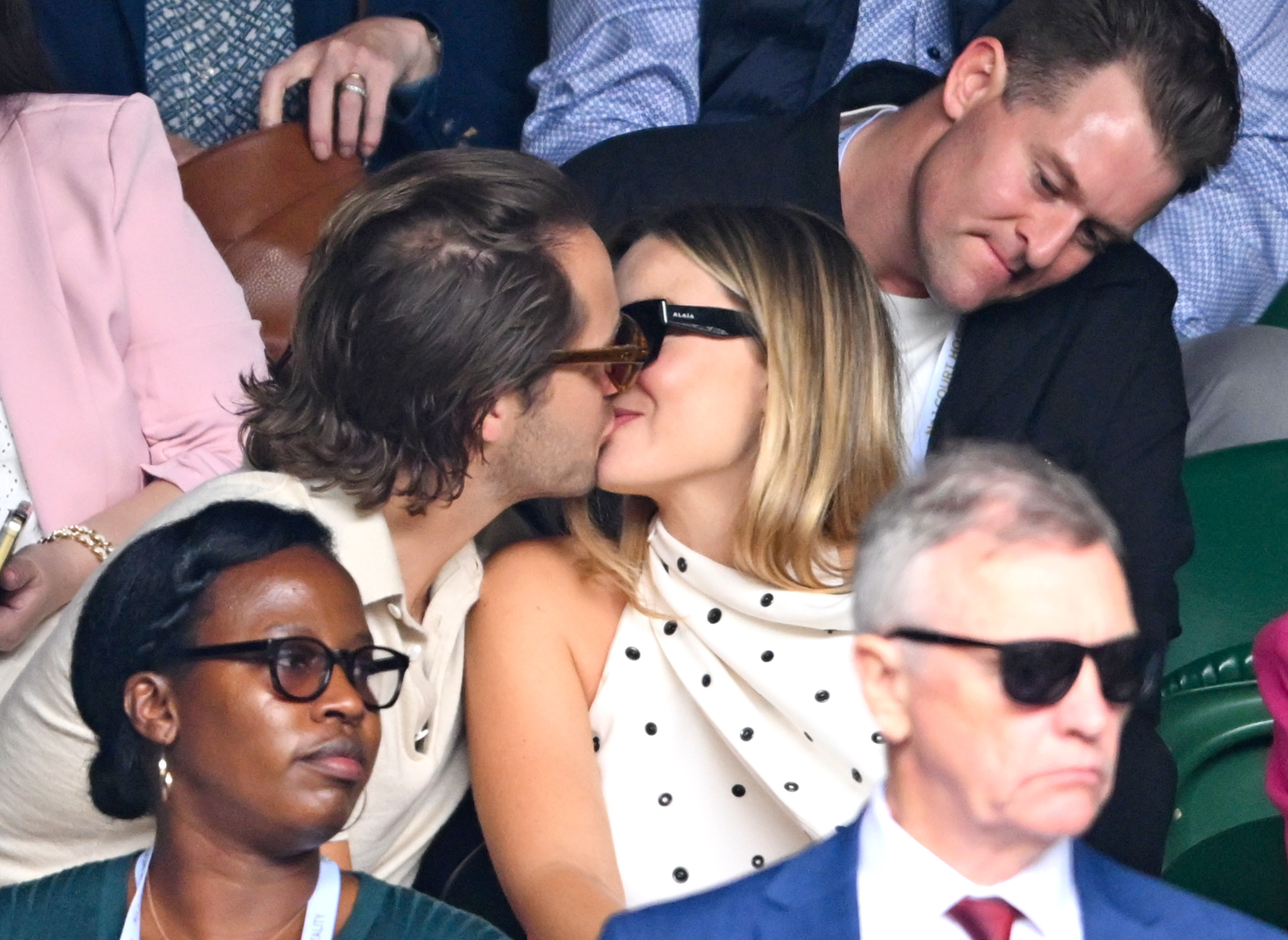 Tom Ackerley and Margot Robbie sharing a kiss on day 12 of the Wimbledon Tennis Championships at the All England Lawn Tennis and Croquet Club on July 12, 2024 in London, England | Source: Getty Images