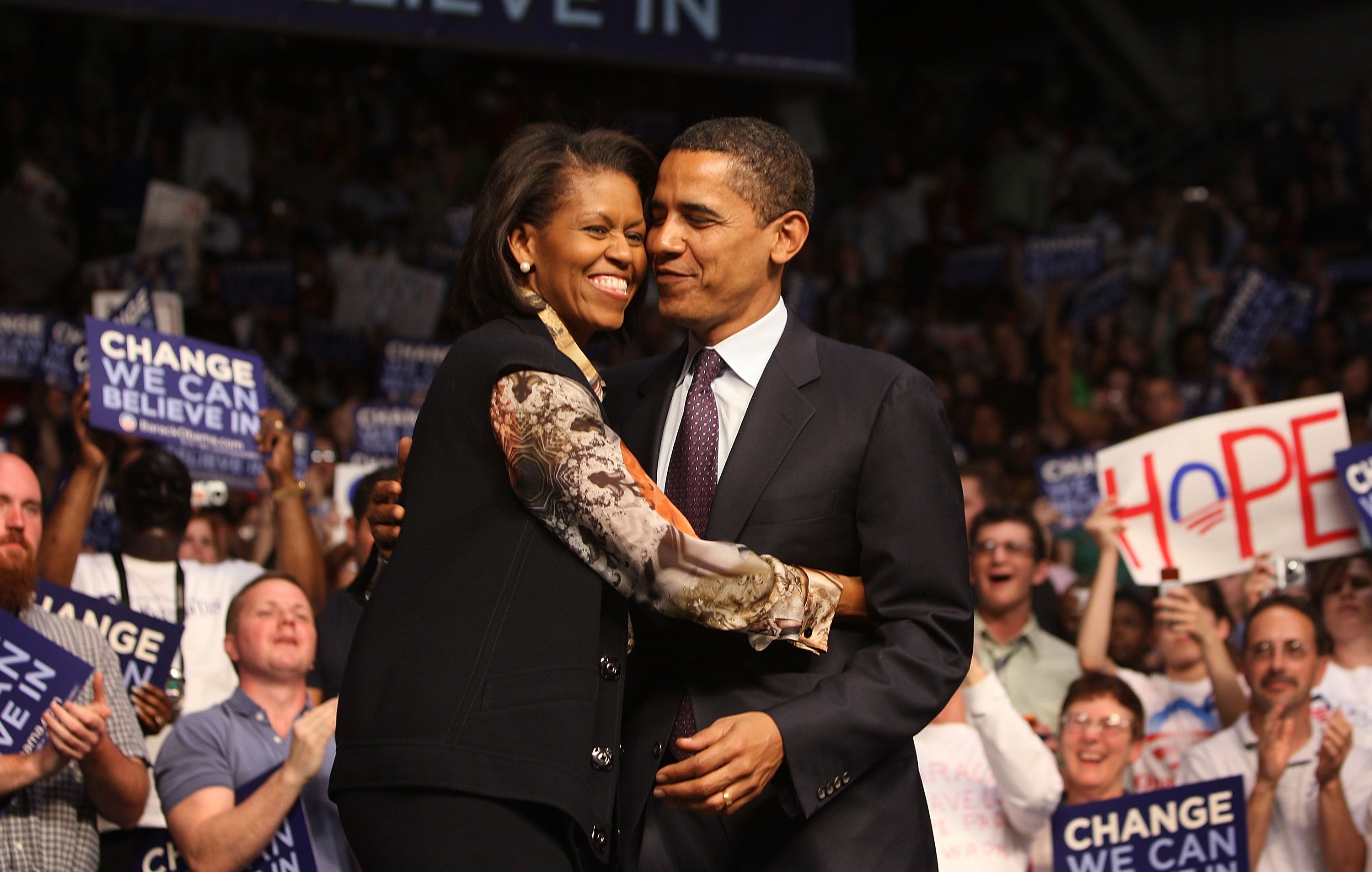 Barack Obama and Michelle Obama embrace each other at a rally April 22, 2008 in Evansville, Indiana. | Source: Getty Images