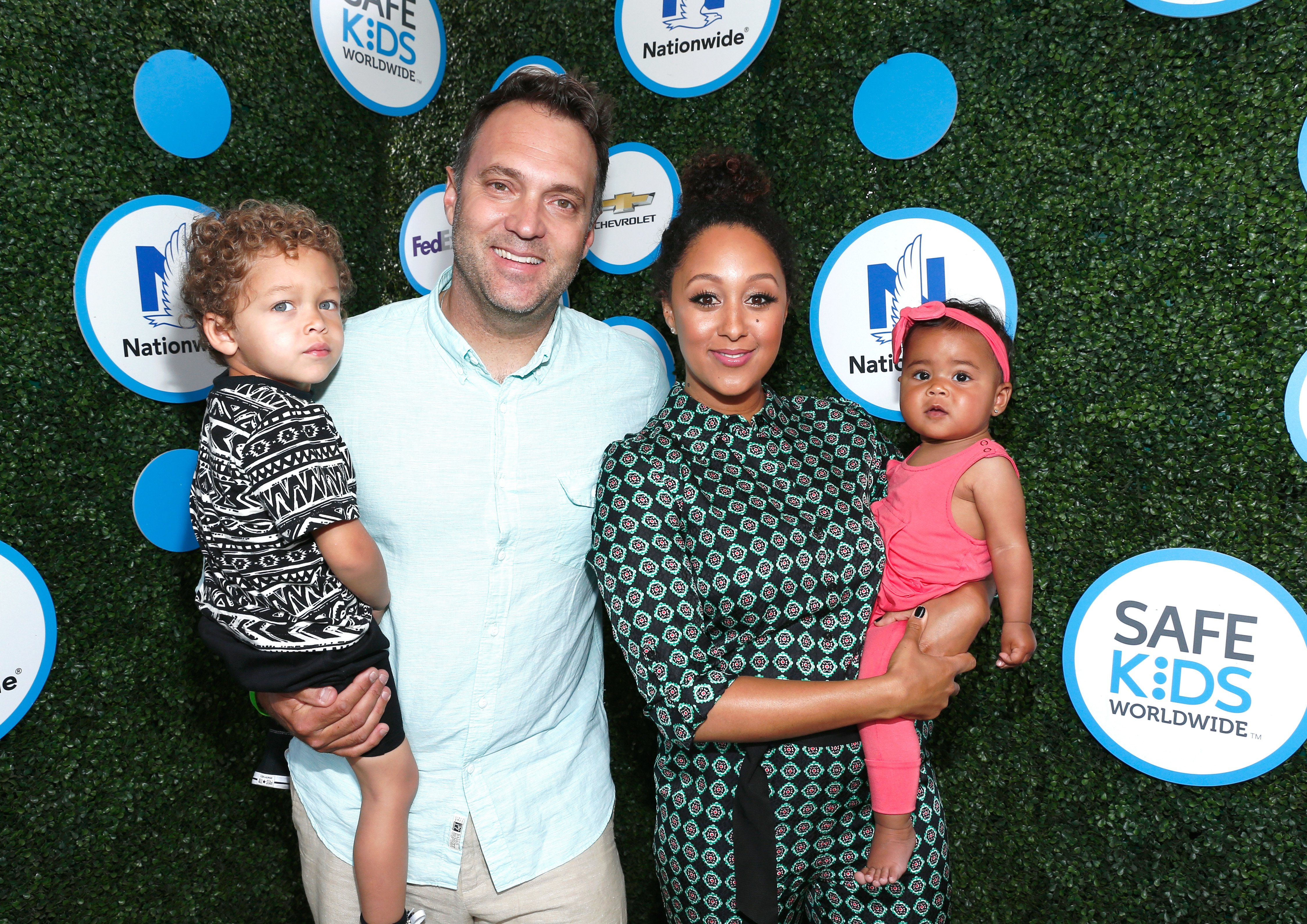 Adam Housley and Tamera Mowry with their two children at the Safe Kids Day at Smashbox Studios on April 24, 2016 in Culver City, California.| Source: Getty Images