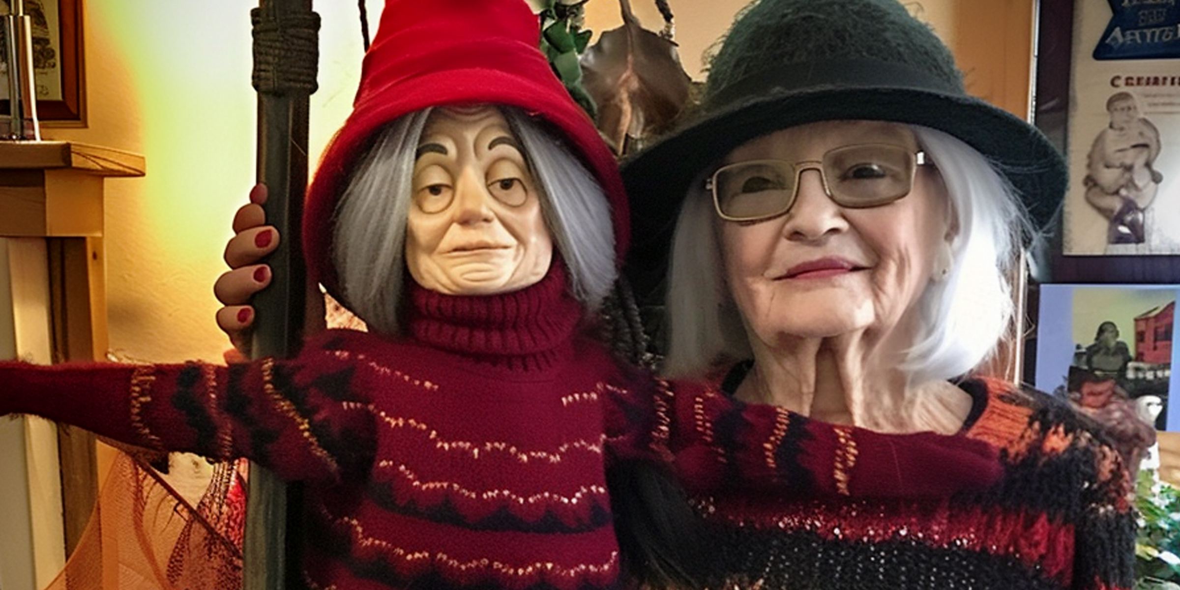 An elderly woman standing next to a witch statue on Halloween | Source: Amomama