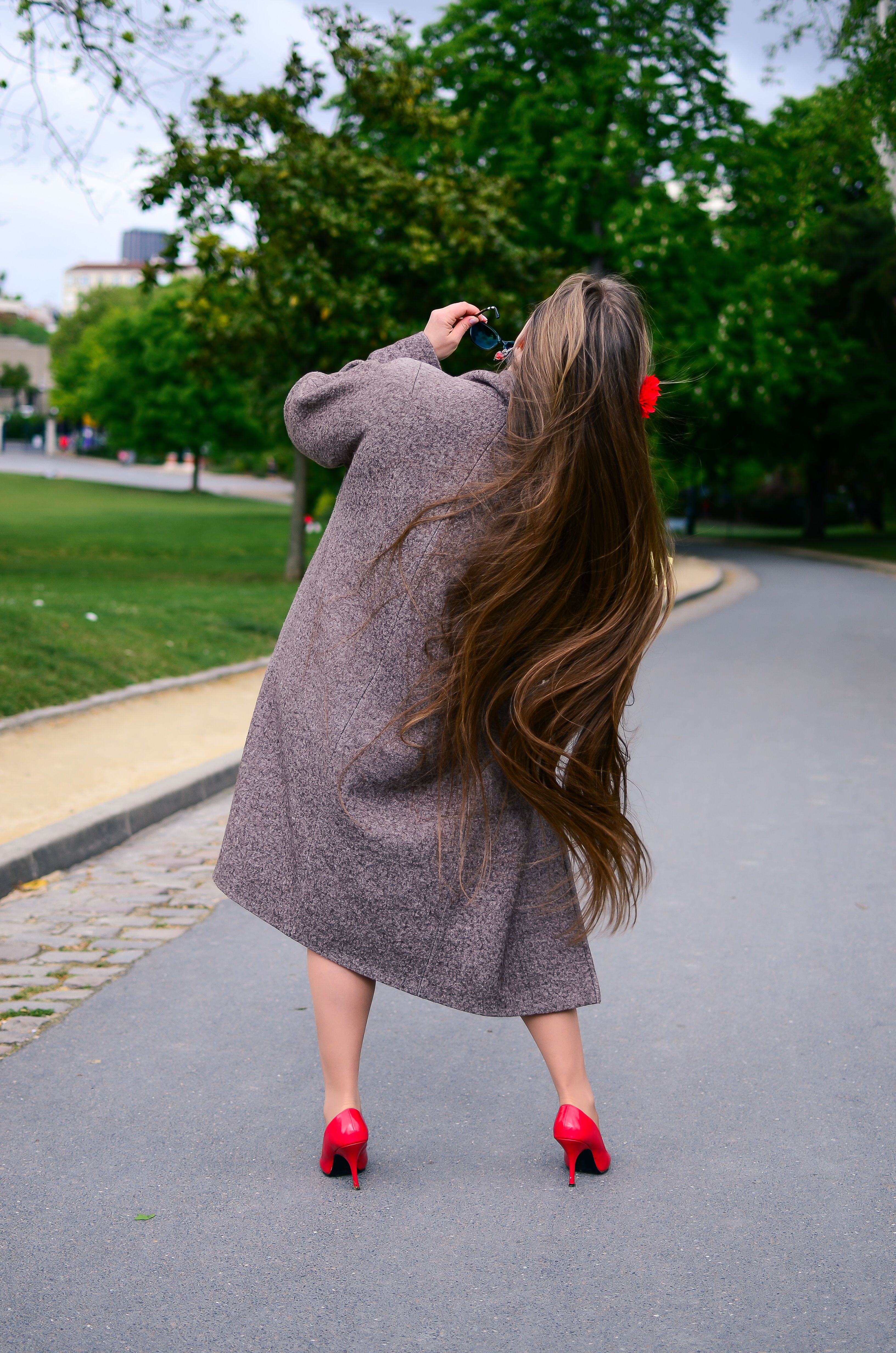 A rear view of a woman with extremely long brunette hair | Source: Shutterstock
