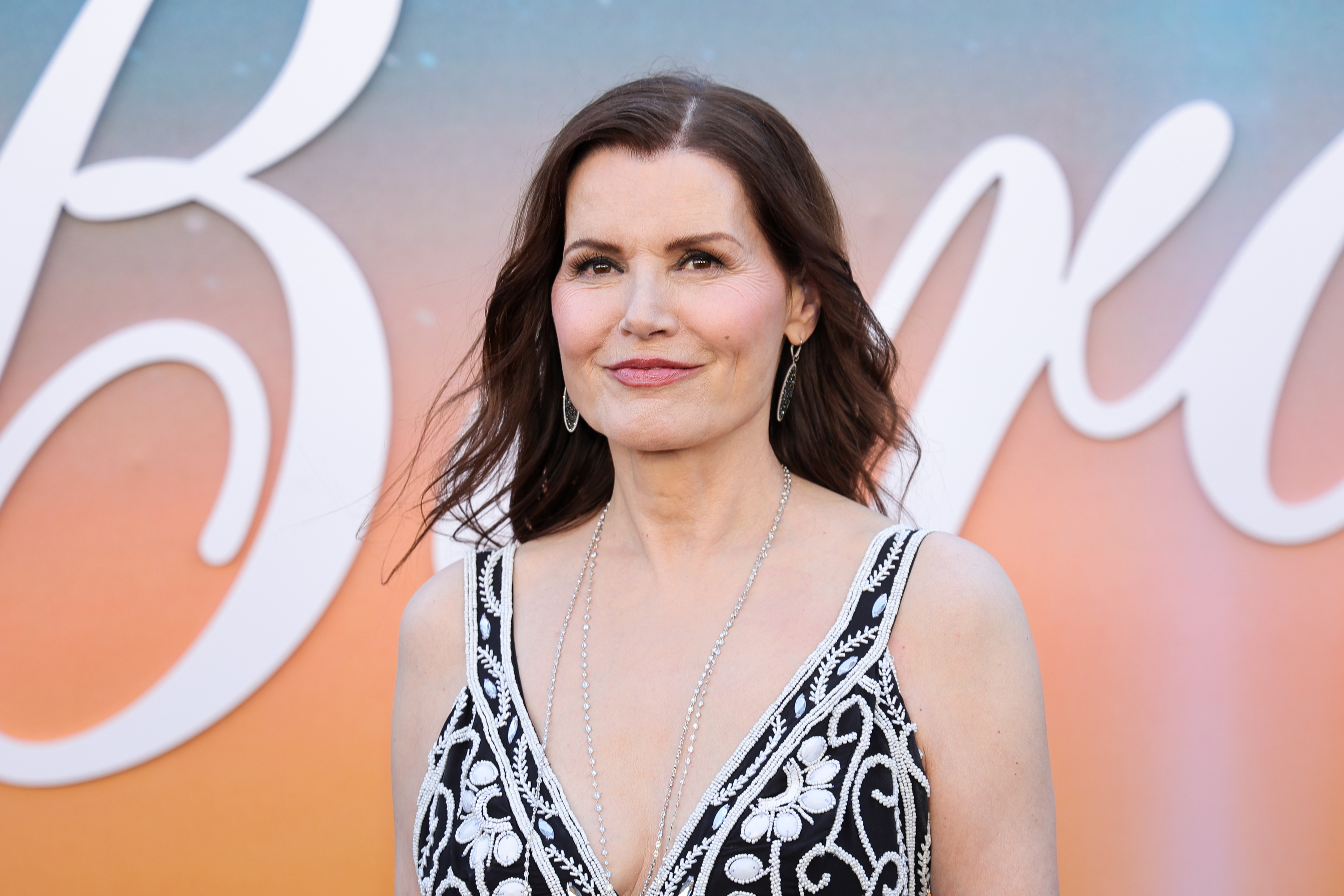 Geena Davis served refined glamour in a close-up moment at the event, showing off the intricate detailing of her deep-neck embroidered dress. With softly tousled hair, silver drop earrings, and a poised expression, the actress radiated effortless confidence at the premiere.