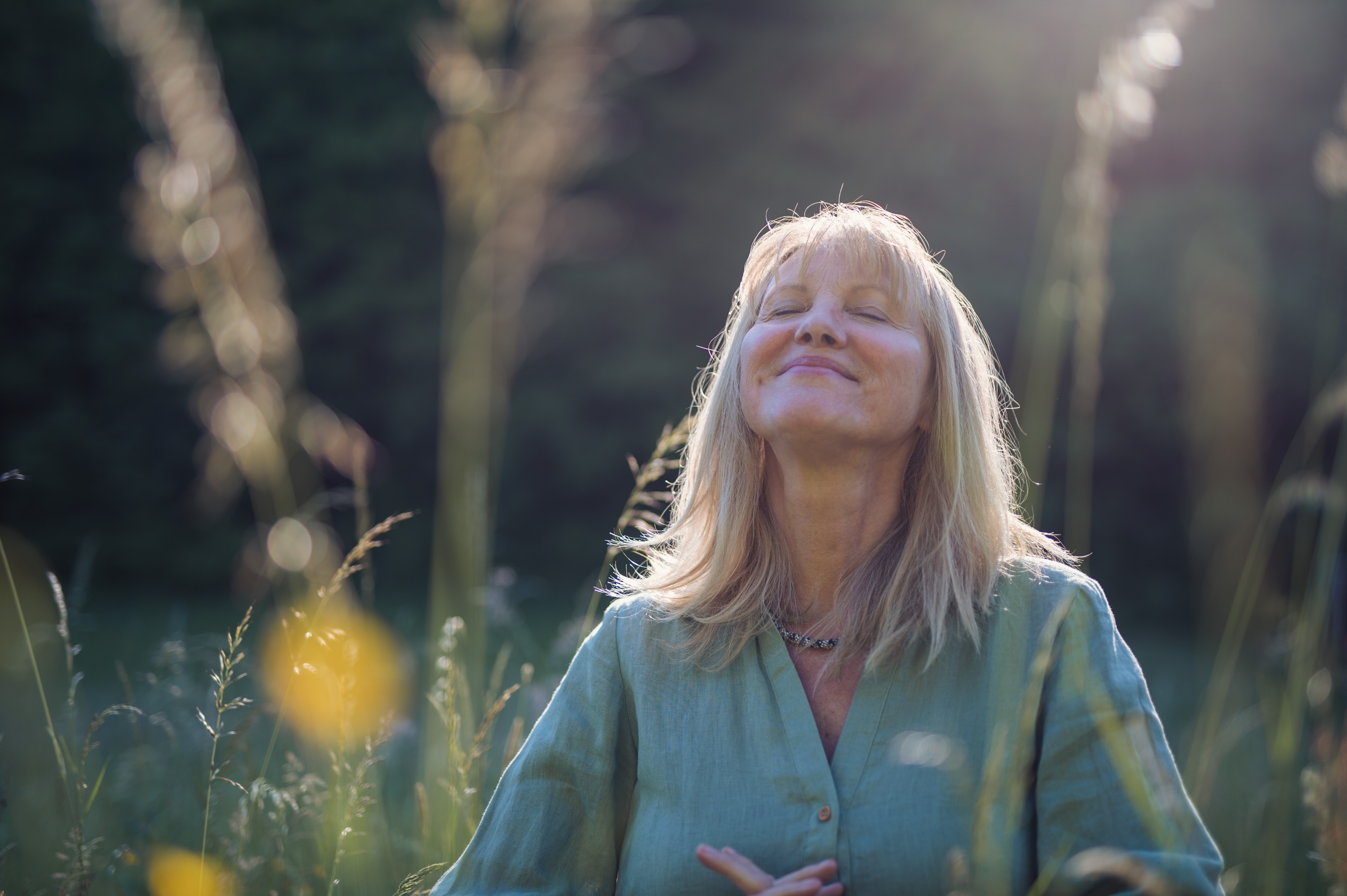 A woman taking a quiet moment surrounded by nature | Source: Shutterstock