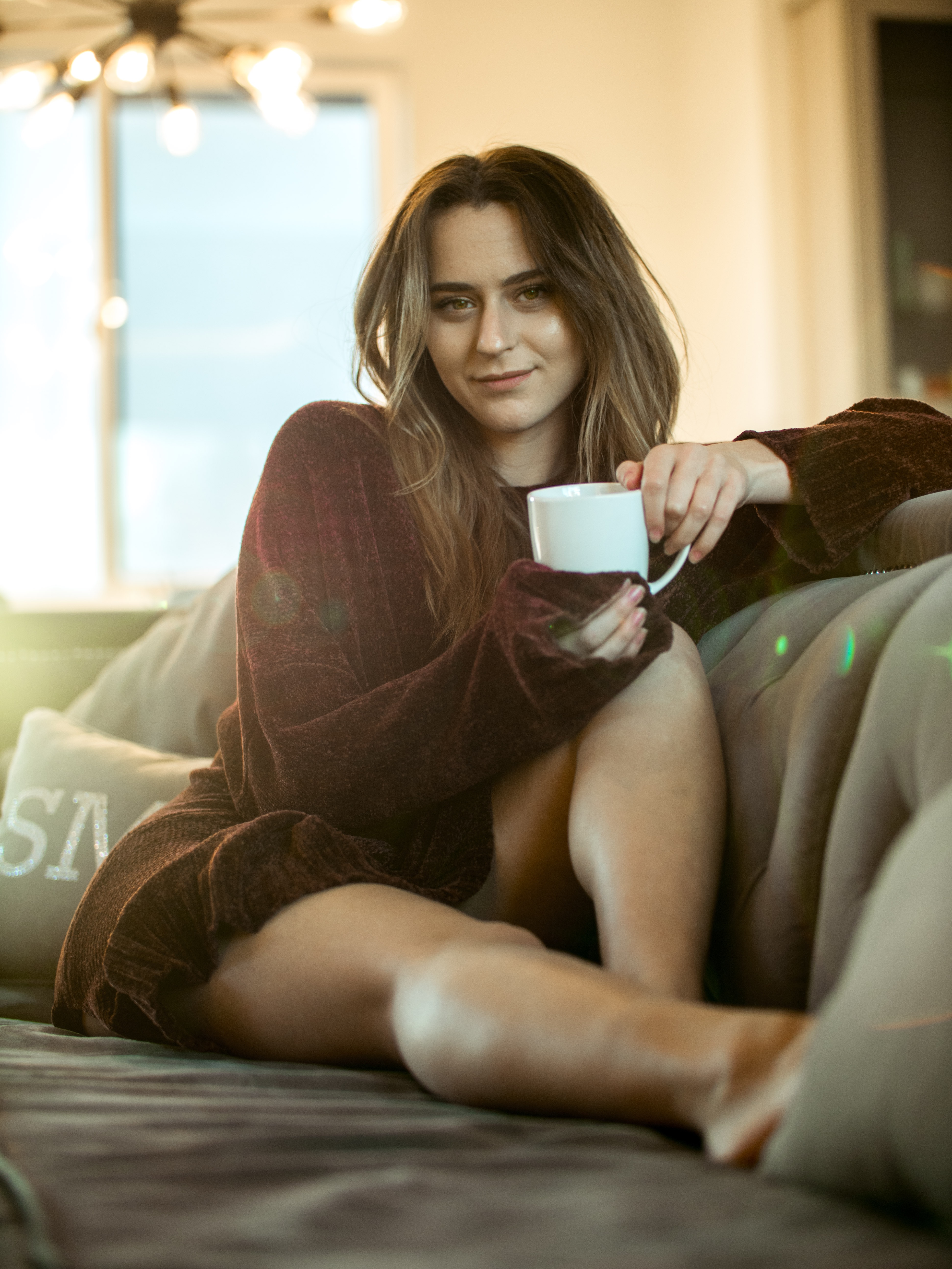 A woman sitting on a couch. | Source: Unsplash