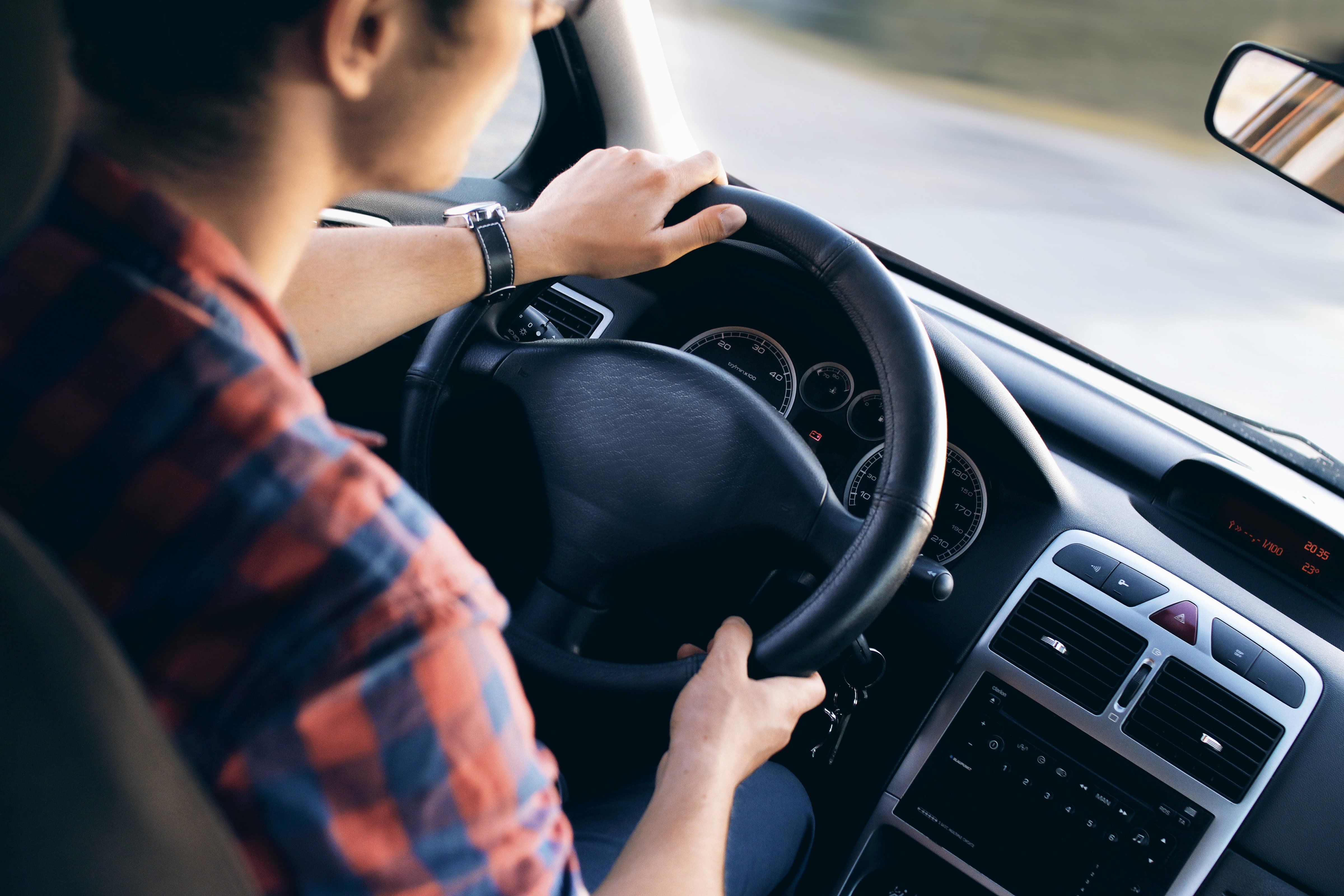 Man sitting in the driver's seat of a car. | Source: Pexels