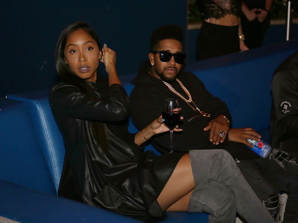 Apryl Jones sips on a glass of wine while sitting next to her boyfriend Omarion at The Pool After Dark at Harrah's Resort on October 23, 2015, in Atlantic City, New Jersey.