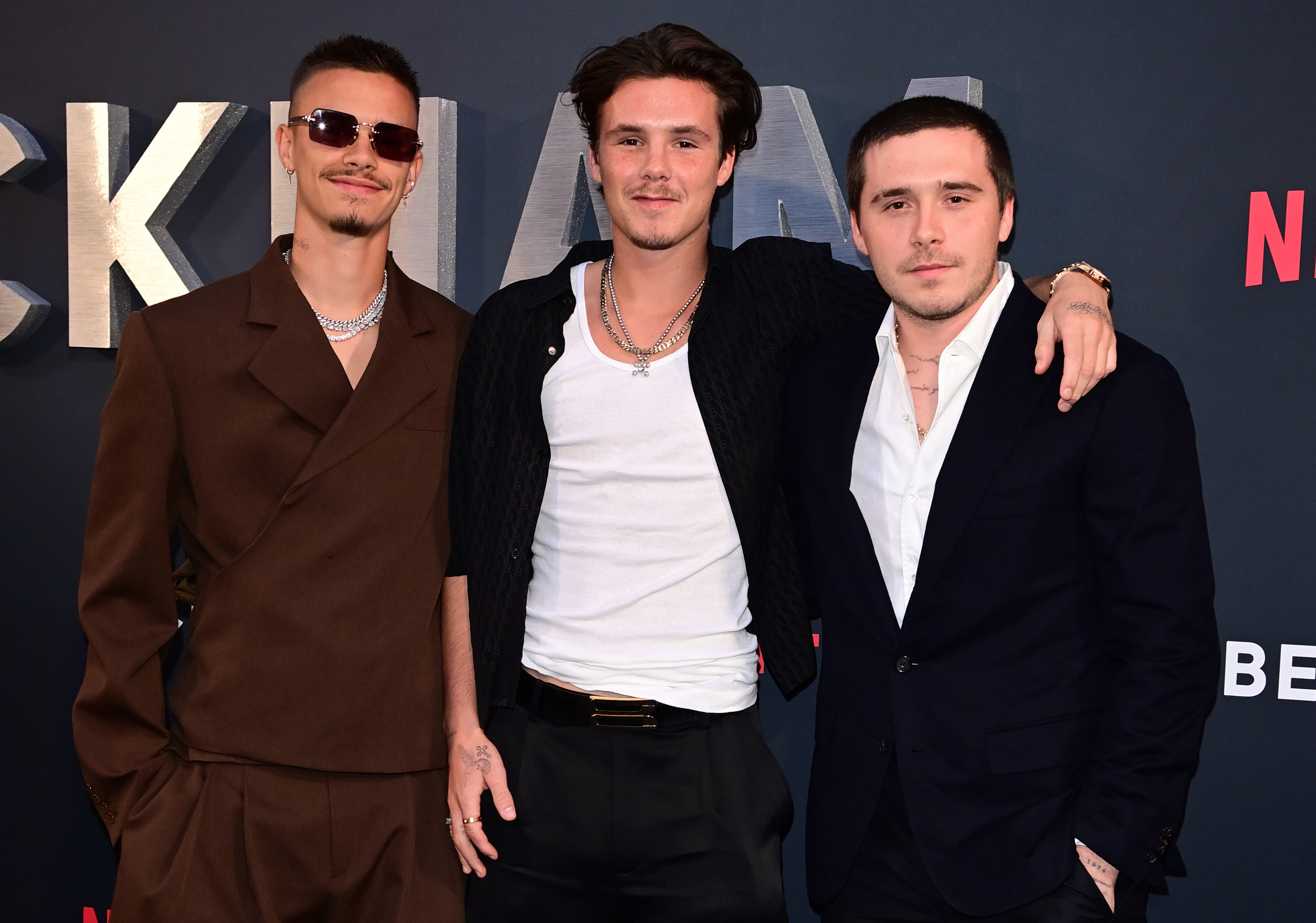 Romeo and Cruz Beckham with Brooklyn Peltz Beckham at the Netflix "Beckham" UK premiere on October 3, 2023, in London, England. | Source: Getty Images
