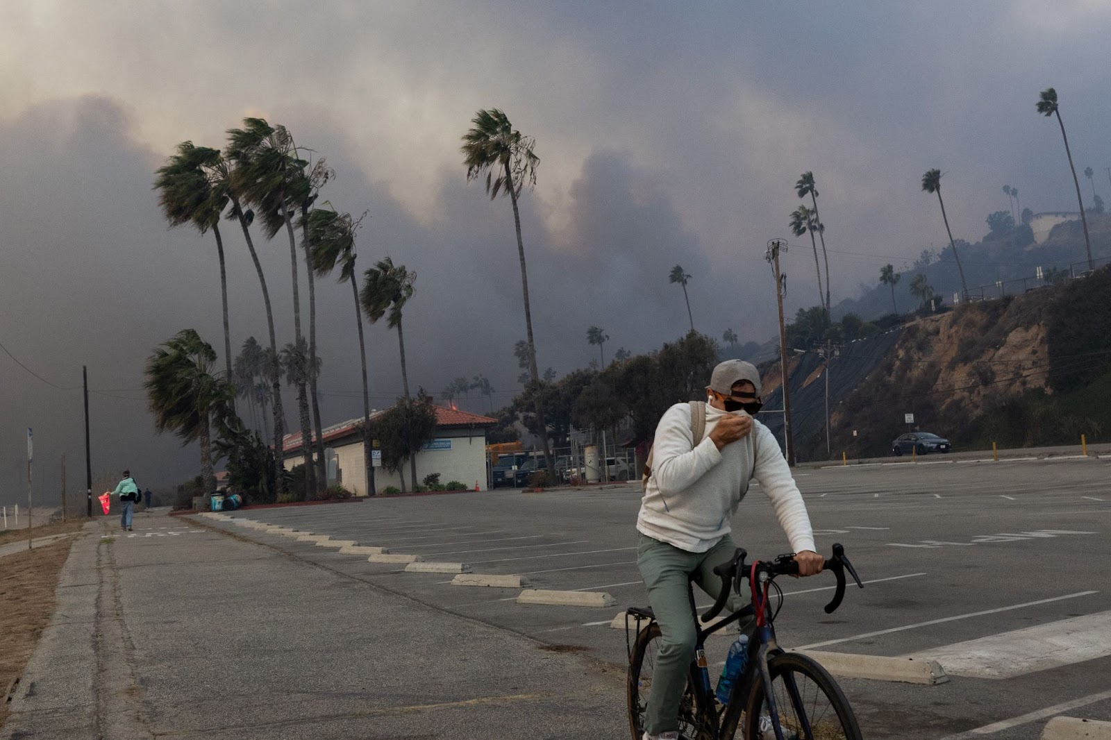 A resident photographed riding through smoke from the Palisades fire on January 7, 2025, in Pacific Palisades, Los Angeles, California. | Source: Getty Images