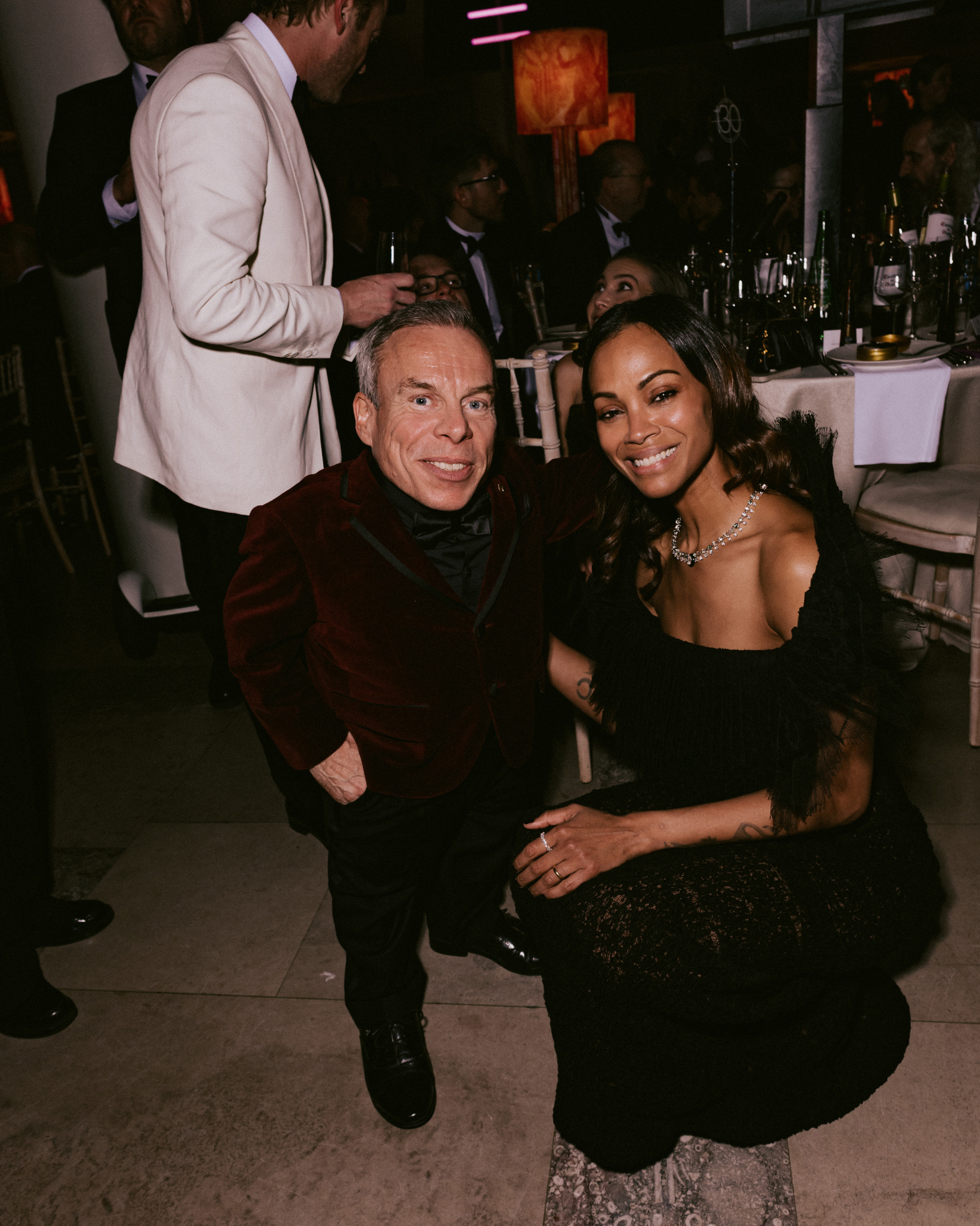 Warwick Davis and Zoe Saldana attend the EE BAFTA Film Awards dinner on February 16, 2025 | Source: Getty Images