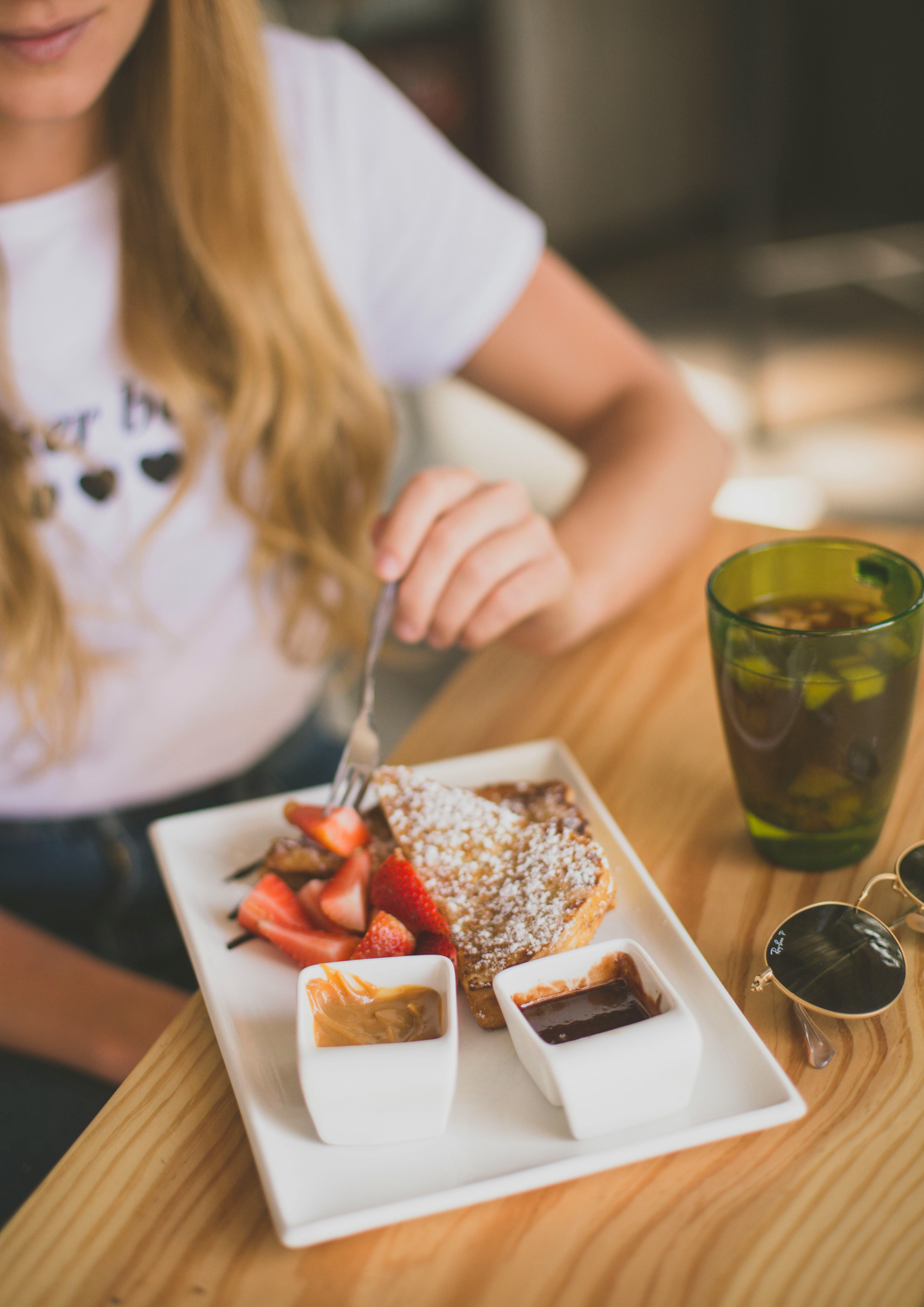 A woman eating breakfast | Source: Unsplash