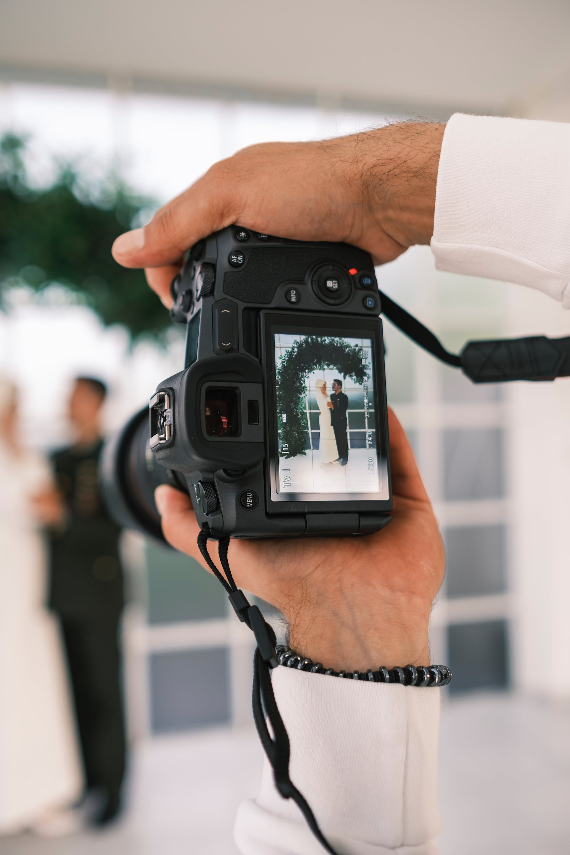 A photographer taking a couple's photo at their wedding | Source: Pexels