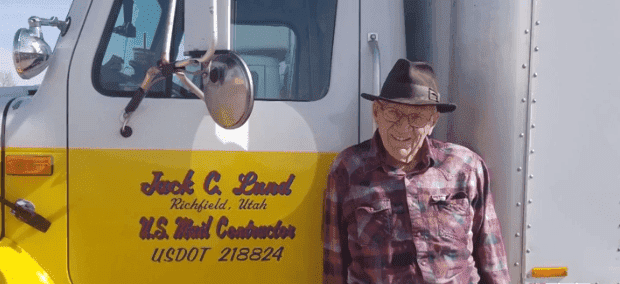 Jack Lund posing next to his mail truck | Photo: KSL-TV
