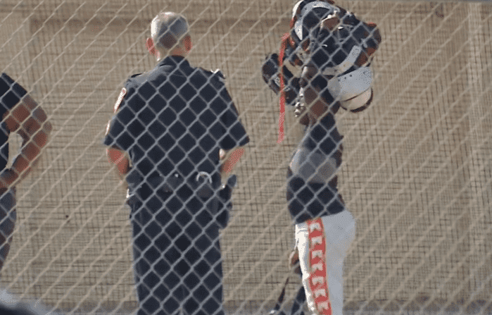 One of the players standing next to a police officer after the shooting | Photo: WFAA