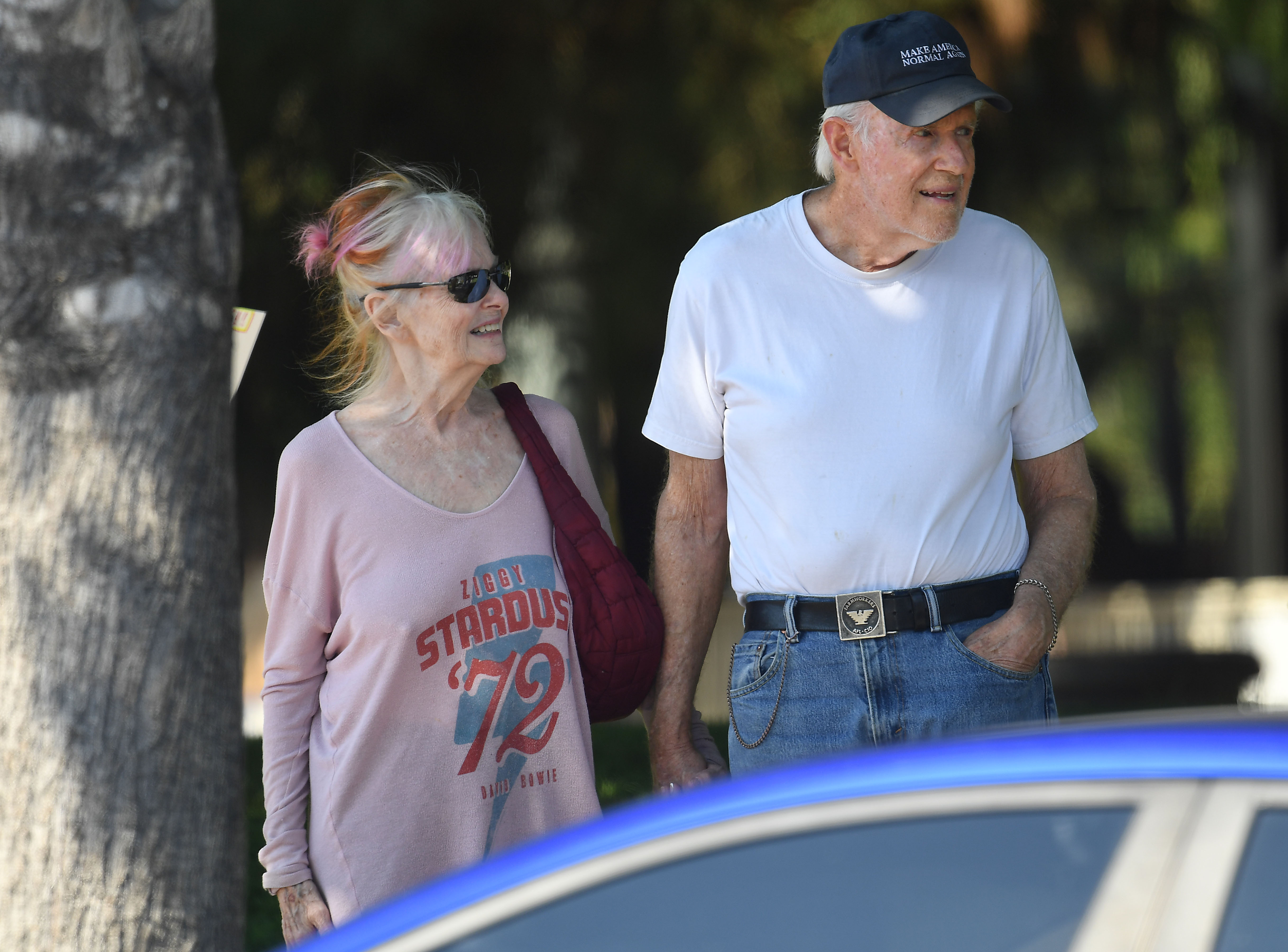 Shelley Fabares smiles beside Mike Farrell as he looks ahead during an outing in Los Angeles on July 18, 2025. | Source: Getty Images