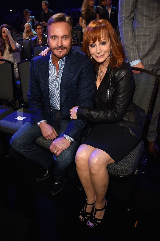 Narvel Blackstock and recording artist Reba McEntire attend the 2014 American Country Countdown Awards. | Source: Getty Images