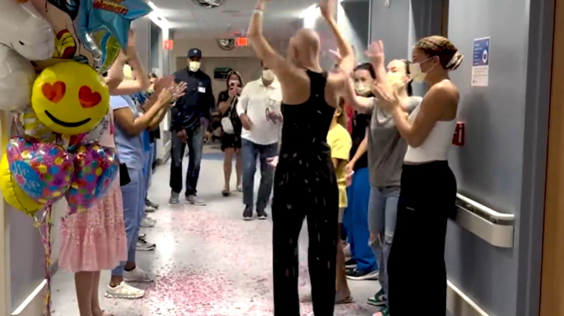 Isabella Strahan walks through a hallway of cheering loved ones during her confetti parade, celebrating her final chemo session, as posted on June 15, 2024 | Source: YouTube/IsabellaStrahan