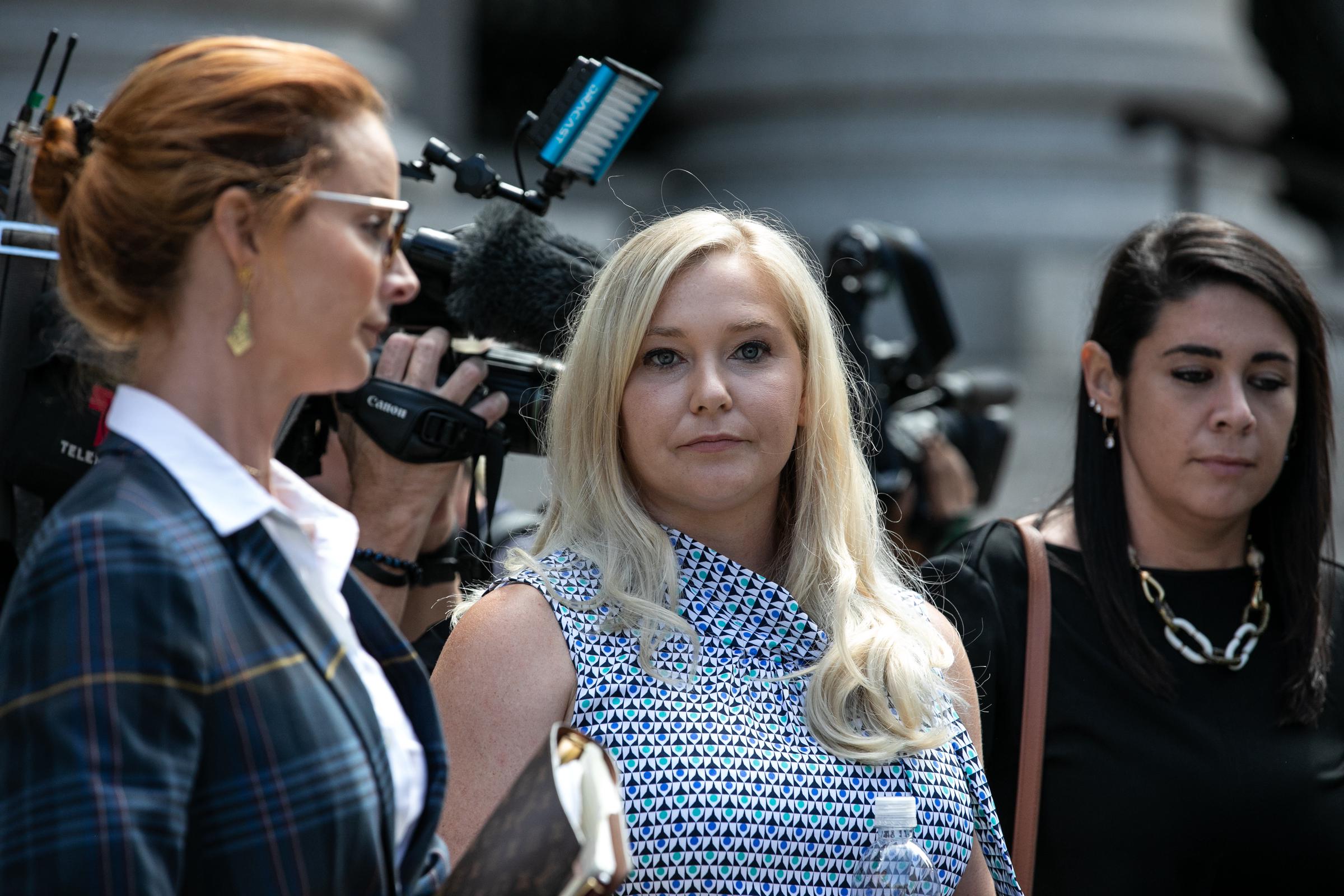 Virginia Giuffre (C), an alleged victim of Jeffrey Epstein, exits from federal court on 27 August 2019 in New York, United States. | Source: Getty Images