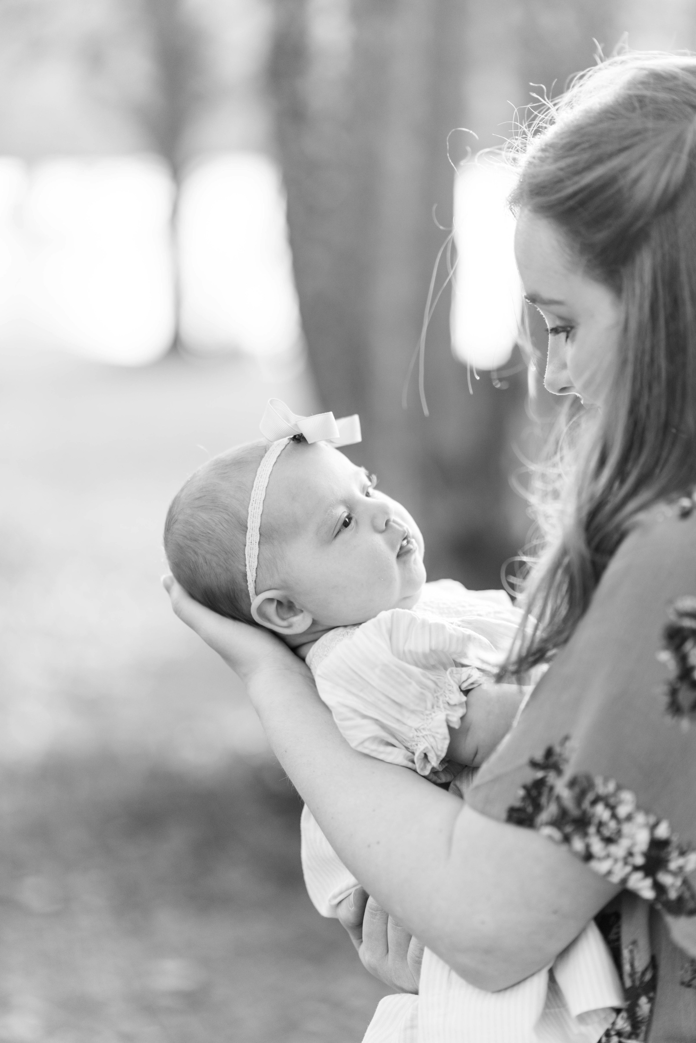 Grayscale shot of a woman holding a baby girl | Source: Unsplash