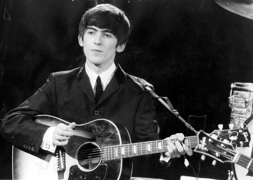 Guitarist and singer George Harrison (1943 - 2001) of the popular Merseybeat group The Beatles, performing during a live concert. | Getty Images / Global Images Ukraine Guitarist and singer George Harrison (1943 - 2001) of the popular Merseybeat group The Beatles, performing during a live concert. | Getty Images / Global Images Ukraine