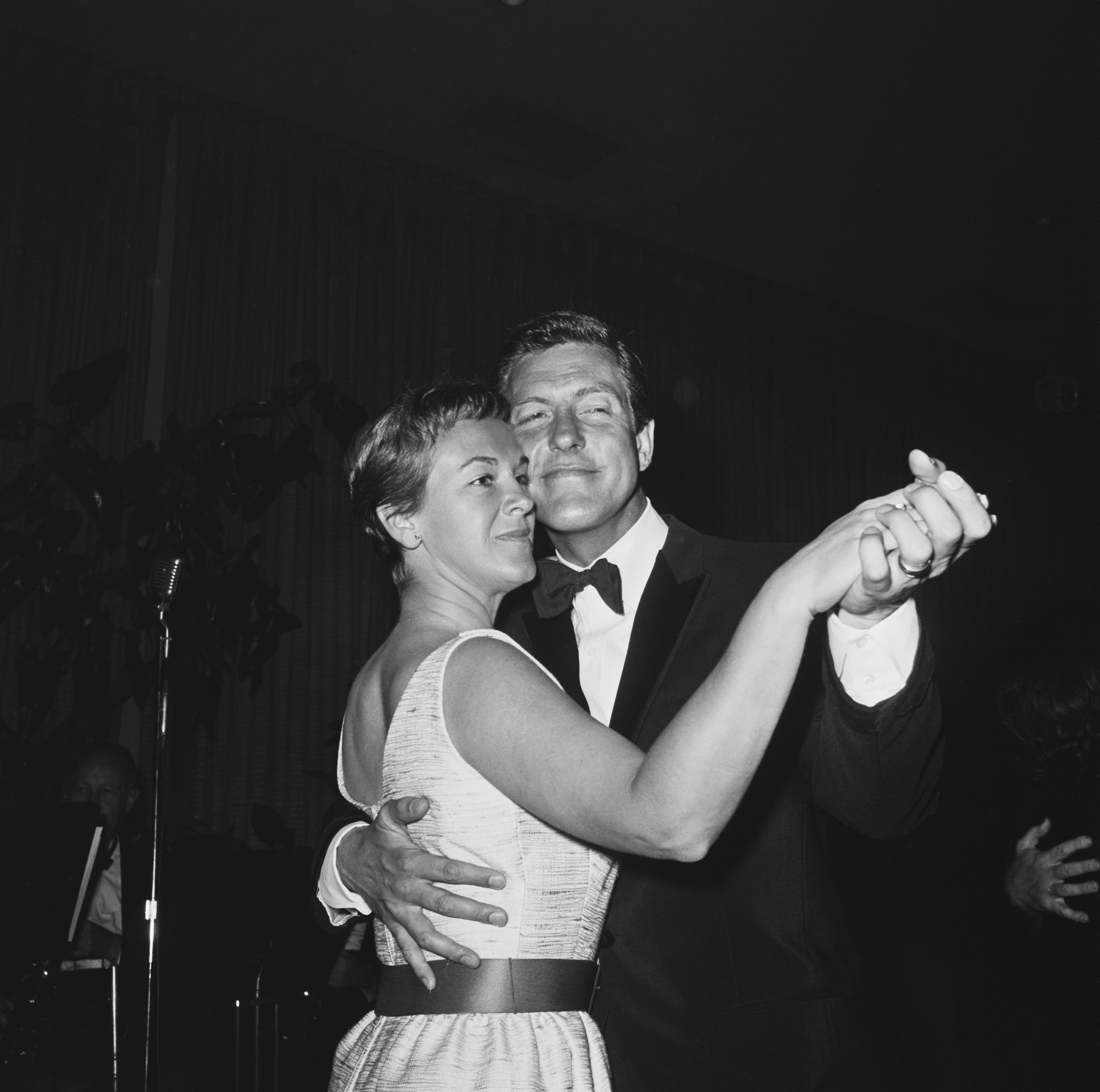 American actor, comedian and singer Dick Van Dyke dancing with his wife Margie at a Screen Producers' Guild party, USA, 1964. |Source: Getty Images