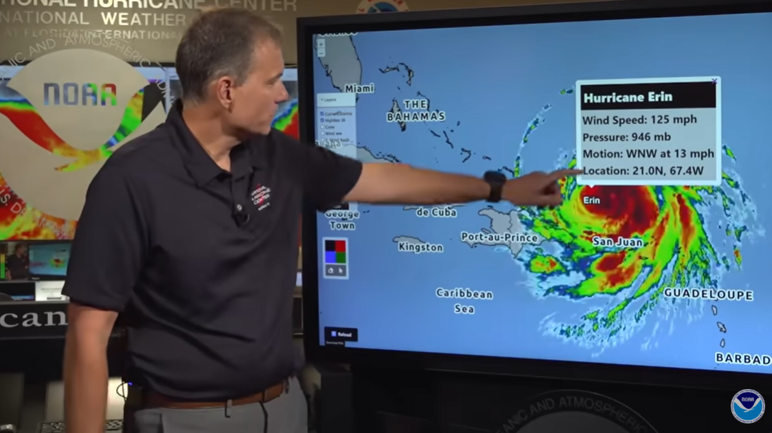 Jamie Rhome of the National Hurricane Center points to Hurricane Erin's location and intensity during a live update, showing sustained winds of 125 mph, as posted on August 17, 2025 | Source: YouTube/nwsnhc