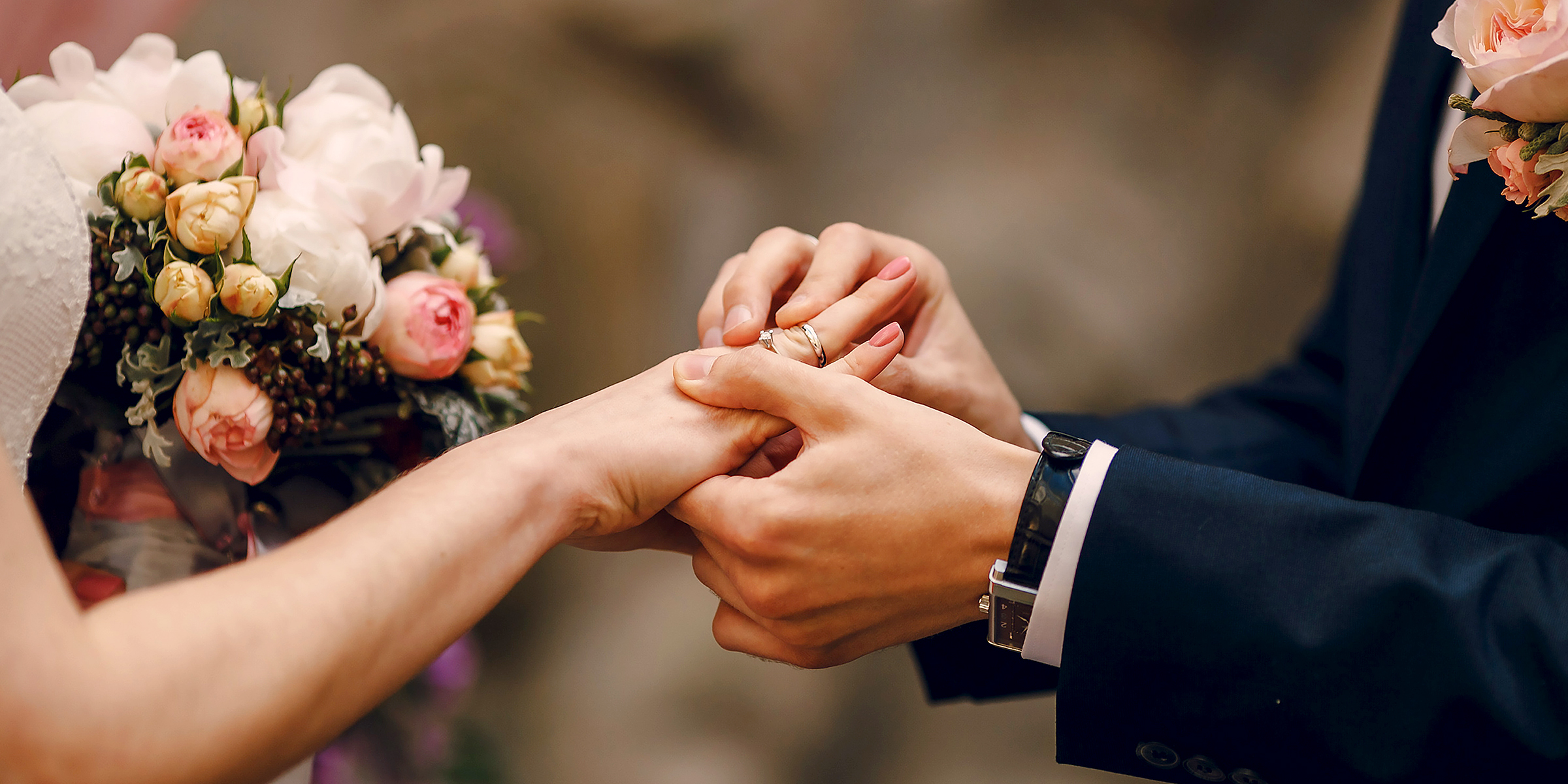A man putting a ring on his bride's finger | Source: Shutterstock