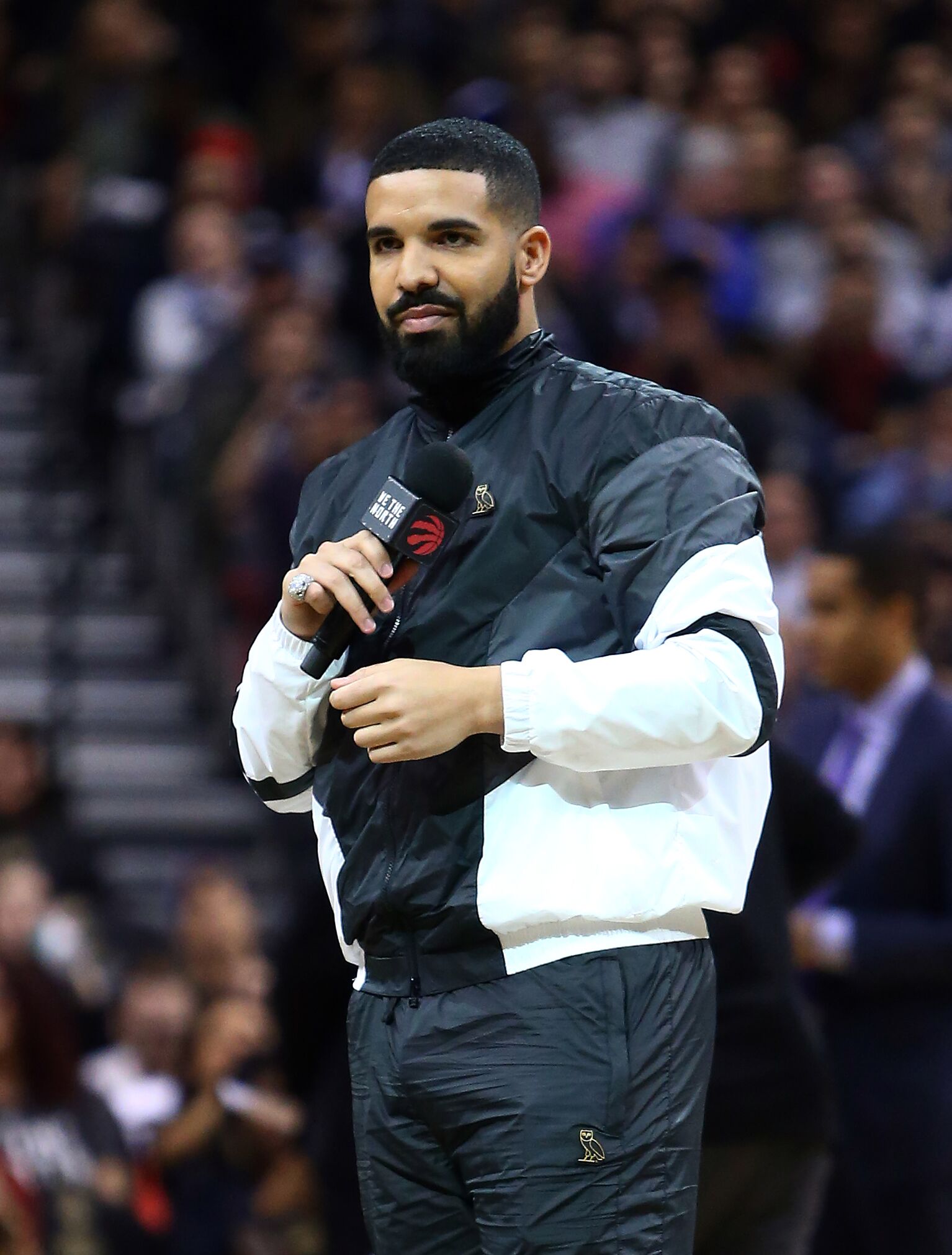  Drake, Toronto Raptors Ambassador, speaks to the crowd on 'Drake Night' during the first half of an NBA game | Getty Images