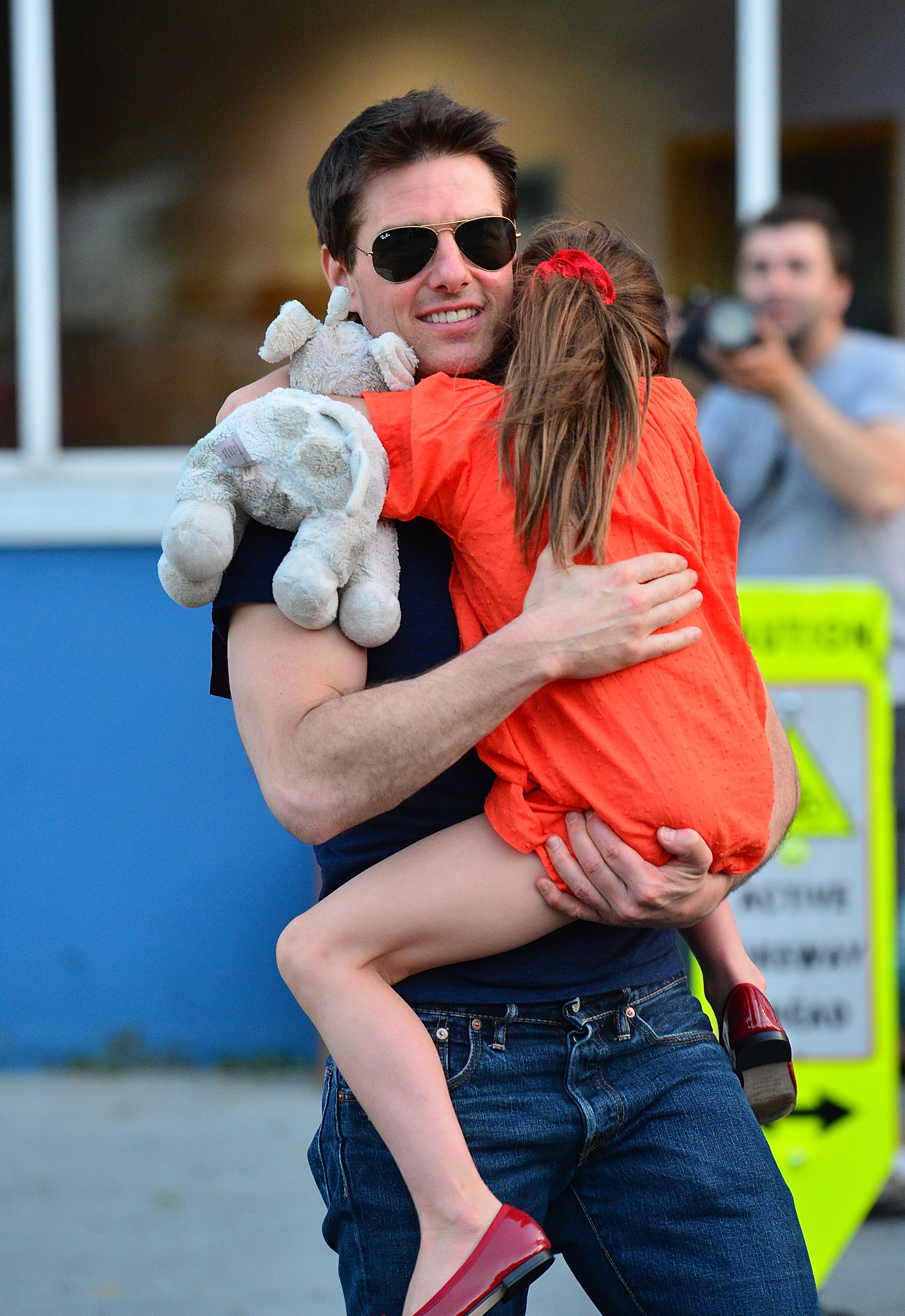 Tom Cruise carries Suri Cruise after the pair leave Chelsea Piers following a father-daughter outing in New York City. | Source: Getty Images