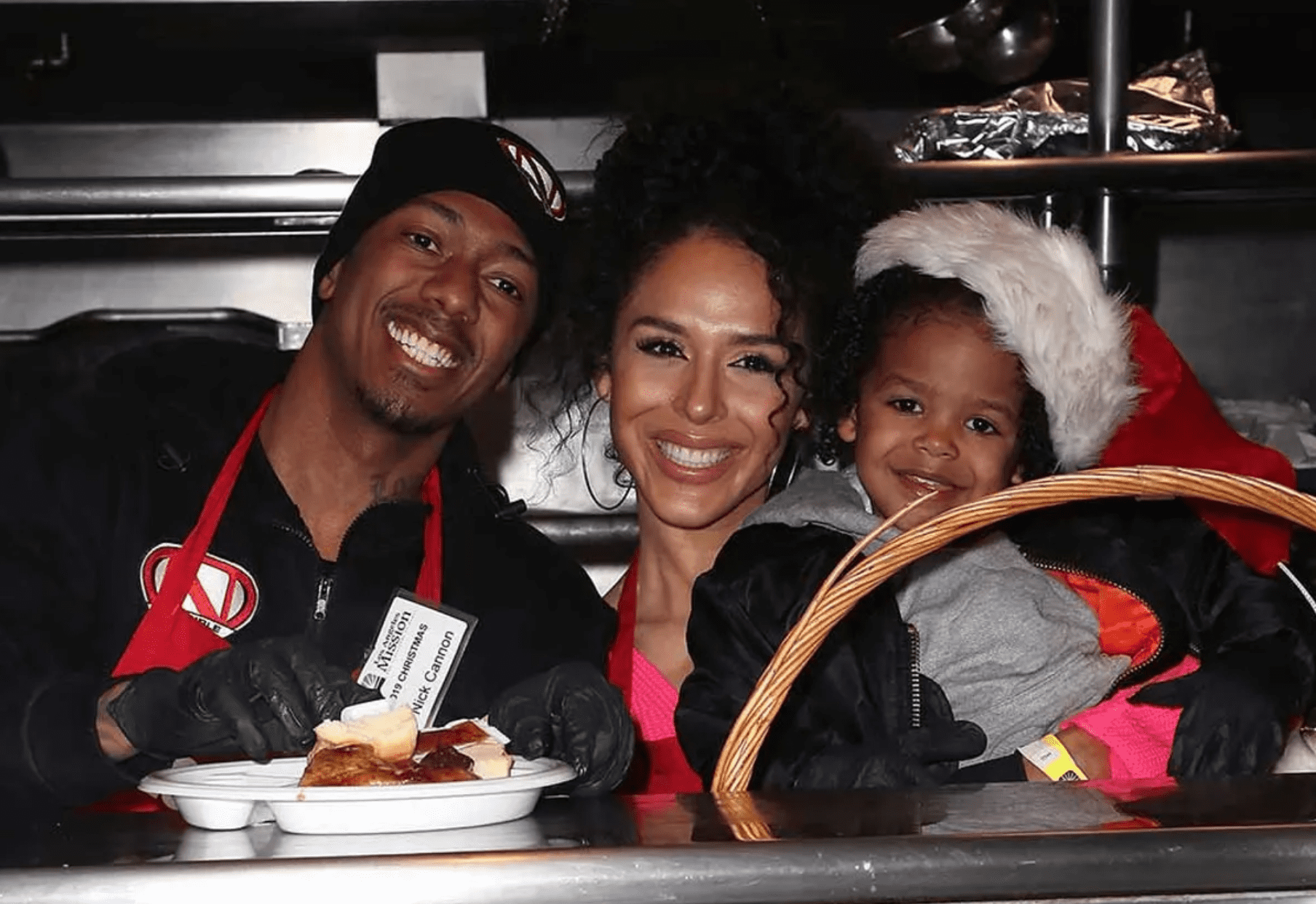 Nick Cannon and Brittany Bell with their son Golden Cannon attending the "Christmas Celebration on Skid Row" at the Los Angeles Mission in December 2019. | Source: Getty Images