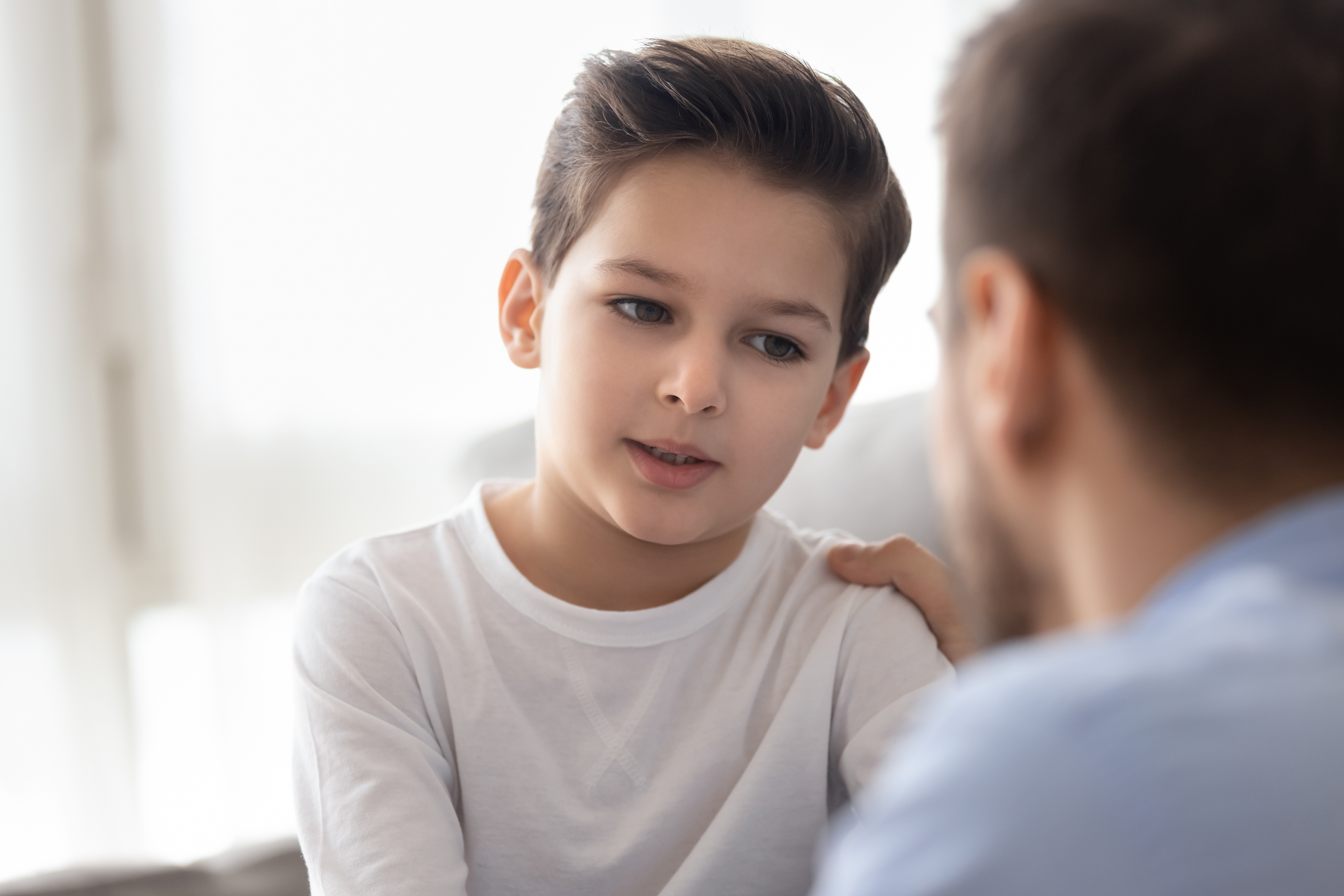 A man talking to a boy | Source: Shutterstock