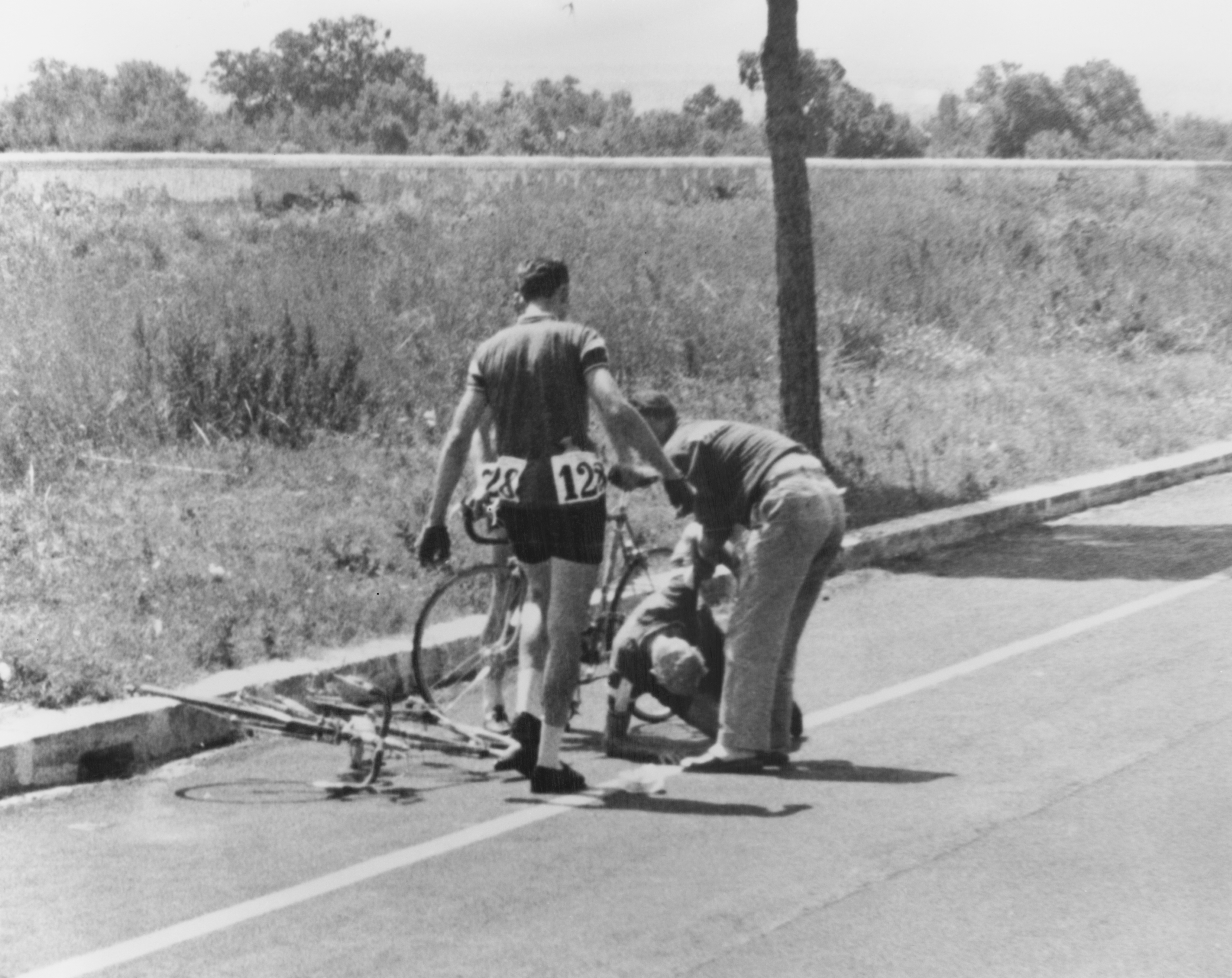 Danish cyclist Knud Enemark Jensen is attended by a Danish official after collapsing with heat stroke and suffering a fractured skull at the Rome Olympics, on August 26, 1960 | Source: Getty Images