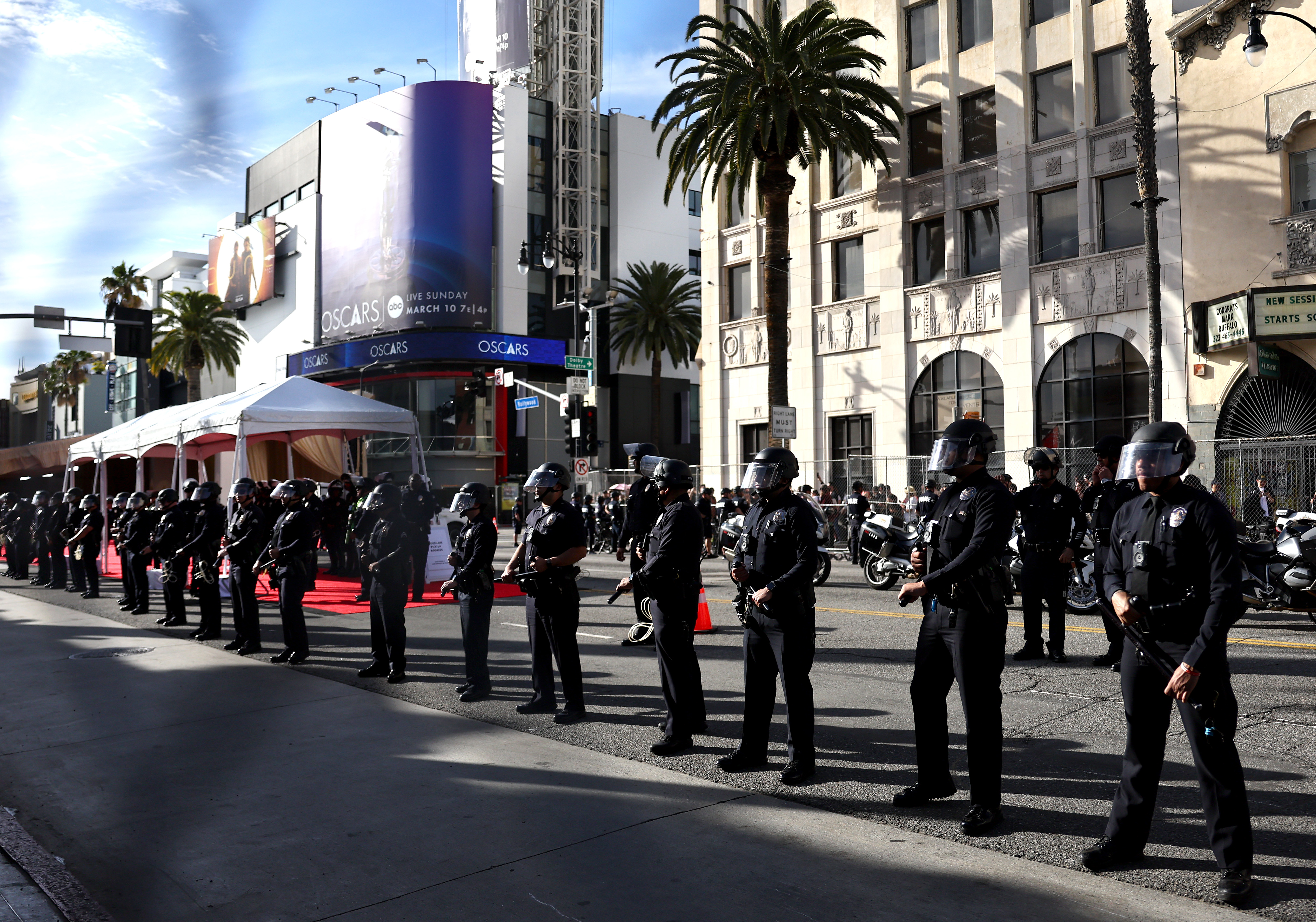 Police keep watch near protestors gathered outside the 96th Academy Awards on March 10, 2024 in Hollywood, California | Source: Getty Images