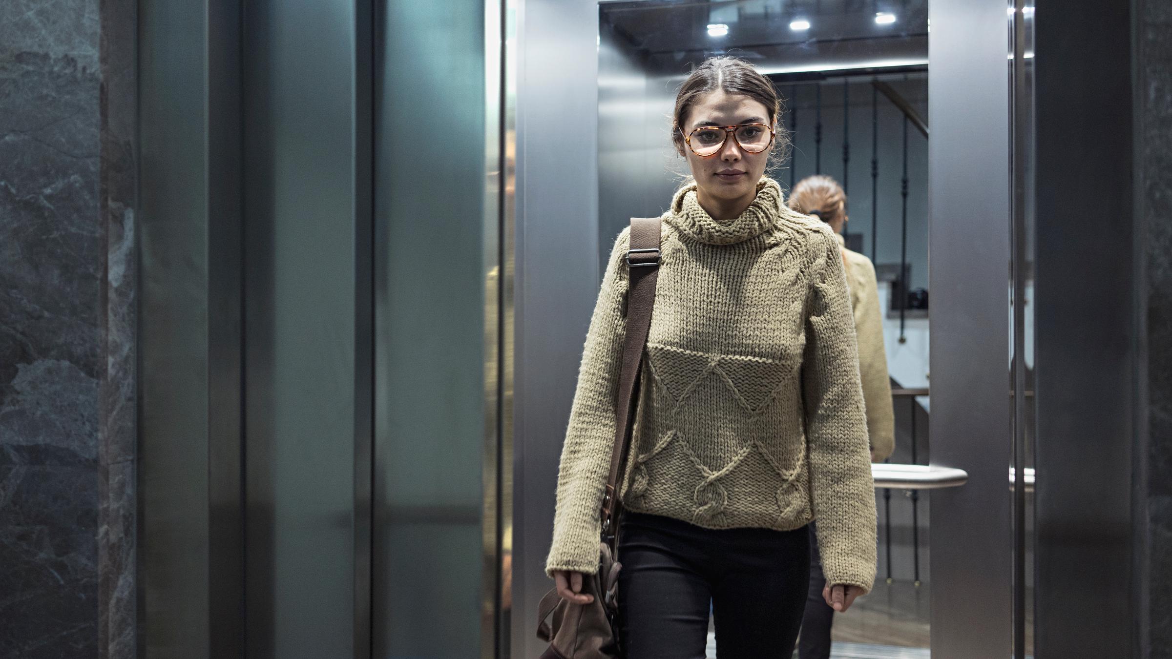 Woman coming out of the elevator | Source: Shutterstock