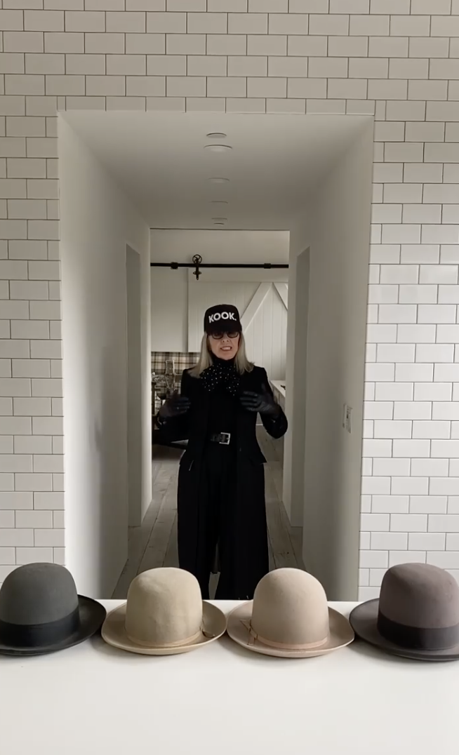 Diane Keaton pictured standing in a hallway lined with white subway tile, with bowler hats displayed in the foreground inside her Sullivan Canyon home, dated May 6, 2020 | Source: Instagram/diane_keaton