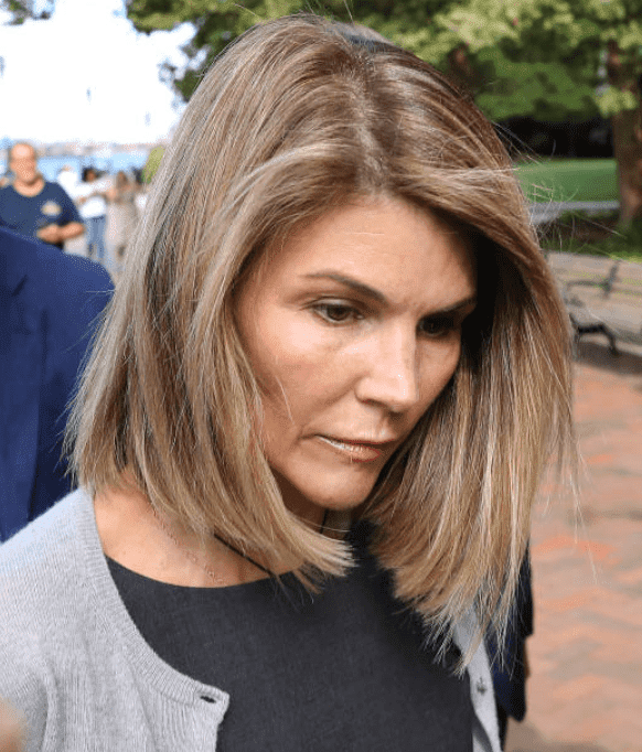 Lori Loughlin followed by cameras with her husband, Mossimo Giannulli, as they leave the John Joseph Moakley United States Courthouse, on Aug. 27, 2019, Boston | Source: Pat Greenhouse/The Boston Globe via Getty Images